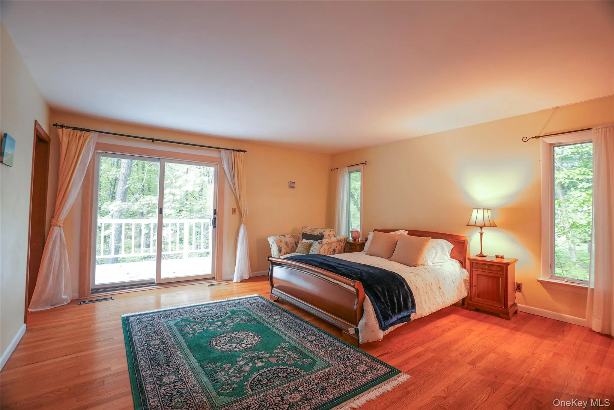 Oversized primary bedroom w/ glass sliders to deck. Oversized primary bedroom w/ glass sliders to deck.