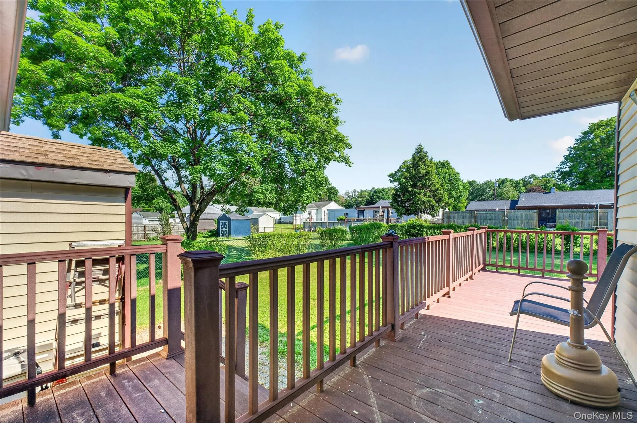 Deck conveniently leads to flat back yard Deck conveniently leads to flat back yard
