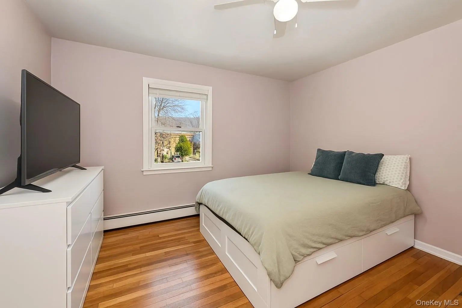 Hardwood flooring and a single window with white trim. There is another window on the left not seen in the photo. Hardwood flooring and a single window with white trim. There is another window on the left not seen in the photo.