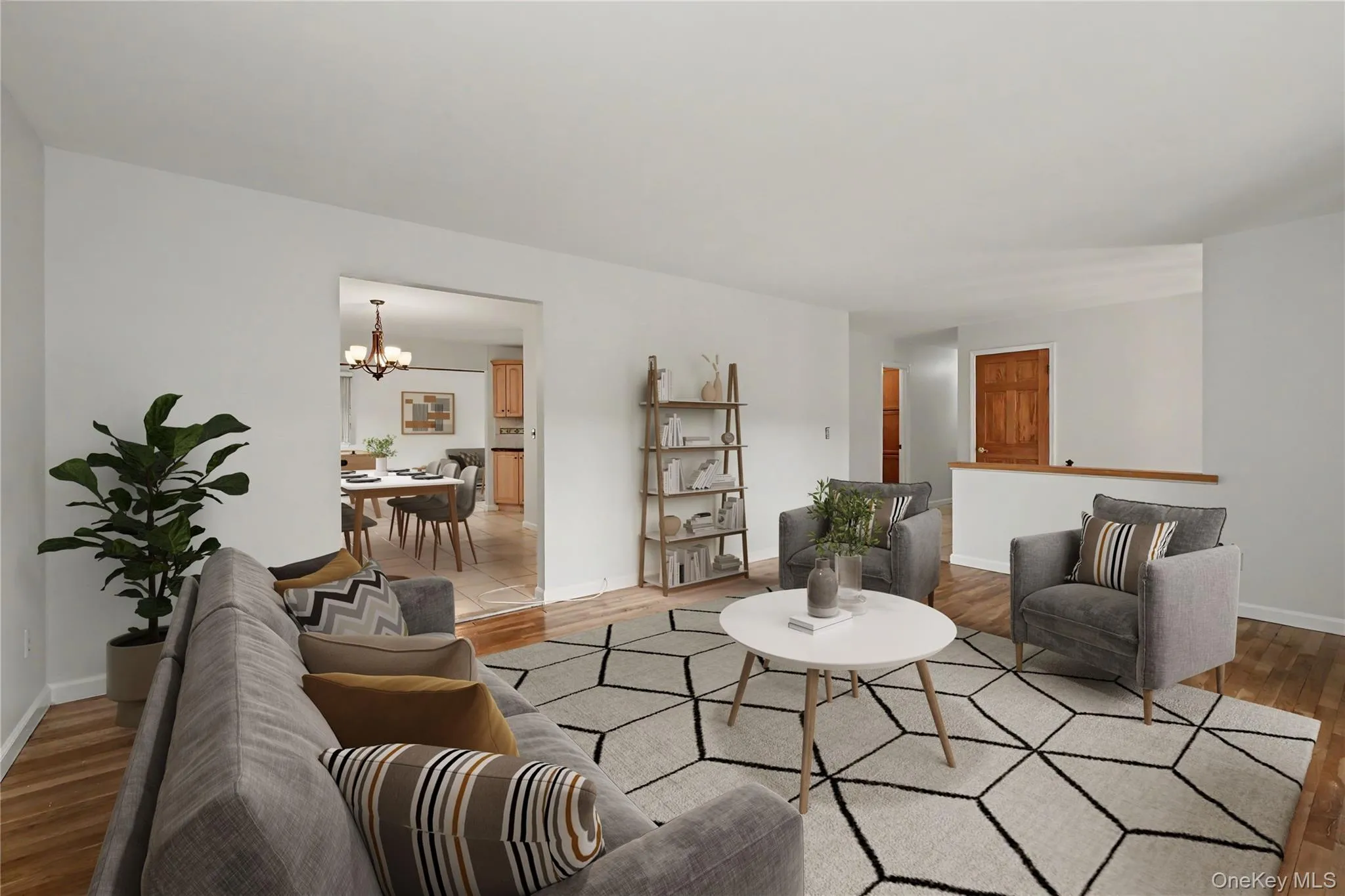 Virtually staged bright living area featuring wood-finish flooring and white painted walls Virtually staged bright living area featuring wood-finish flooring and white painted walls