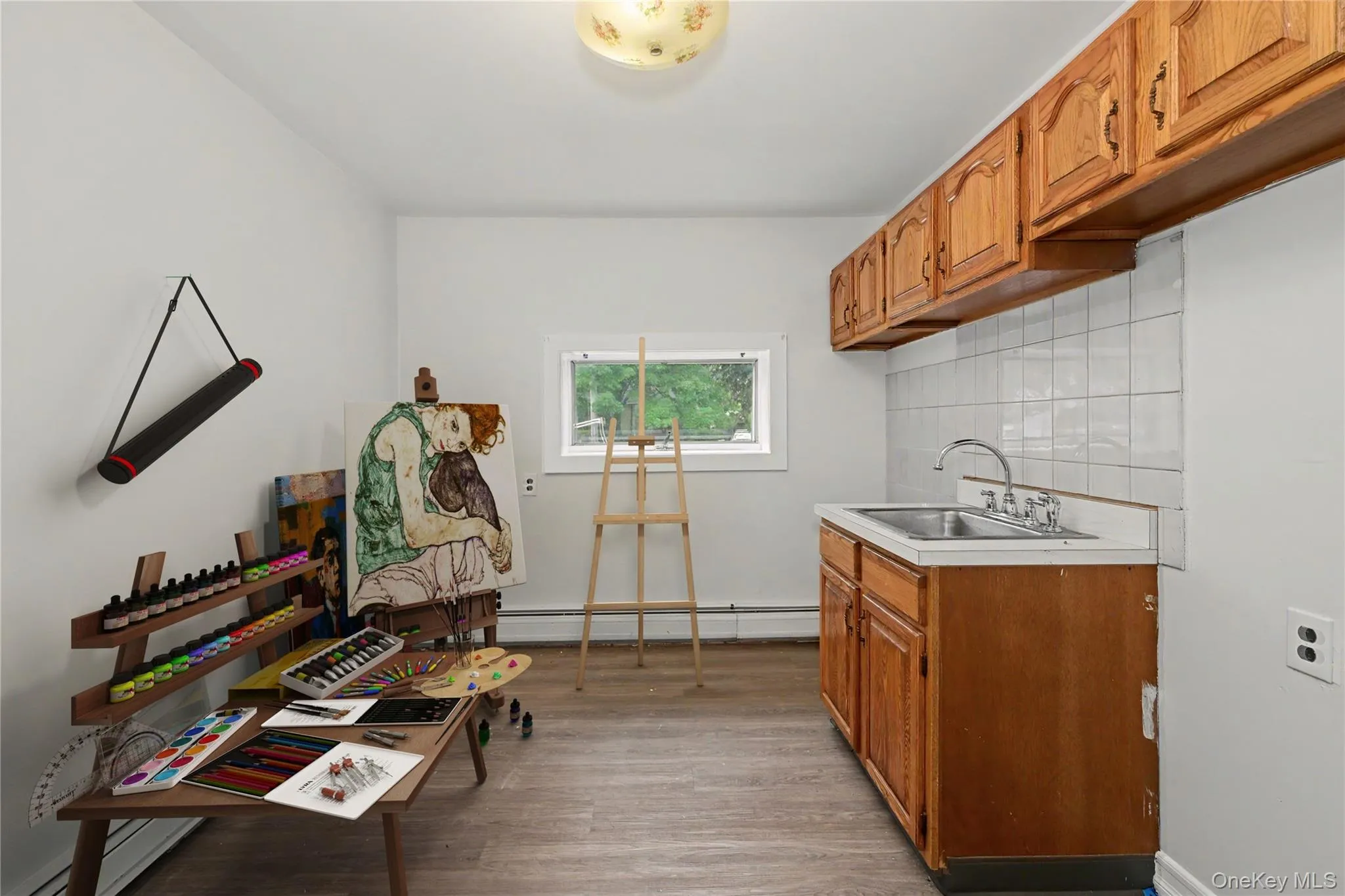 Virtually staged artist studio. Can be set up as a mud room as a door (unseen) on the left leads to the 1Car Garage. Virtually staged artist studio. Can be set up as a mud room as a door (unseen) on the left leads to the 1Car Garage.
