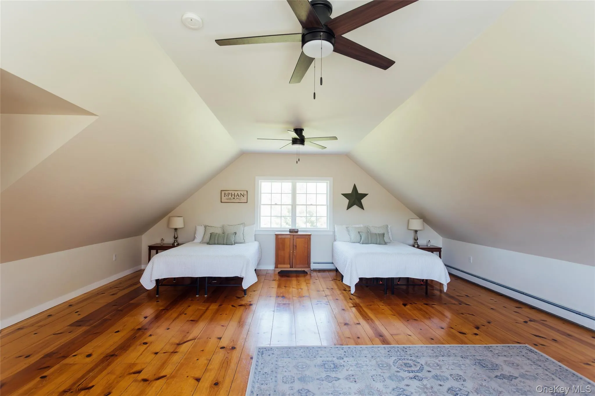 Expansive upper-level flex space with wide-plank wood floors and abundant natural light Expansive upper-level flex space with wide-plank wood floors and abundant natural light
