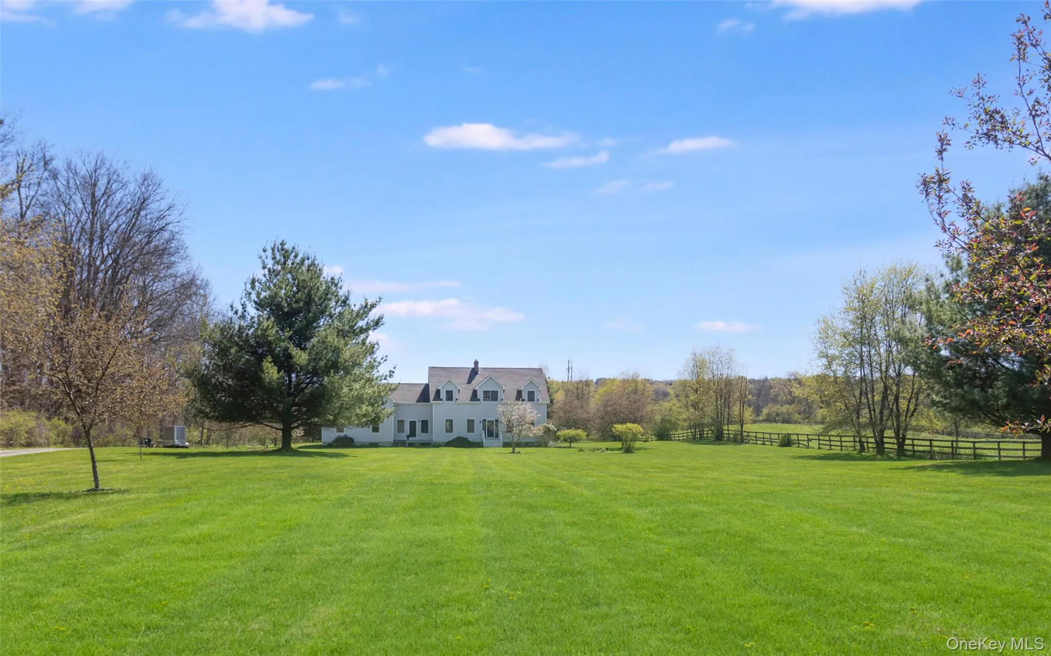 Sweeping backyard views highlighting the home’s open acreage and Hudson Valley setting Sweeping backyard views highlighting the home’s open acreage and Hudson Valley setting