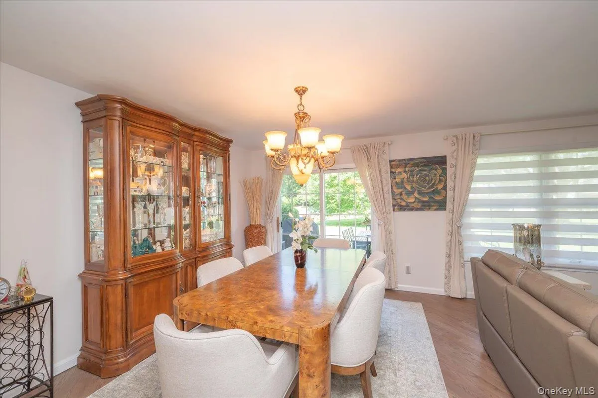 Dining space featuring wood-finish flooring, a sliding glass door providing exterior access Dining space featuring wood-finish flooring, a sliding glass door providing exterior access
