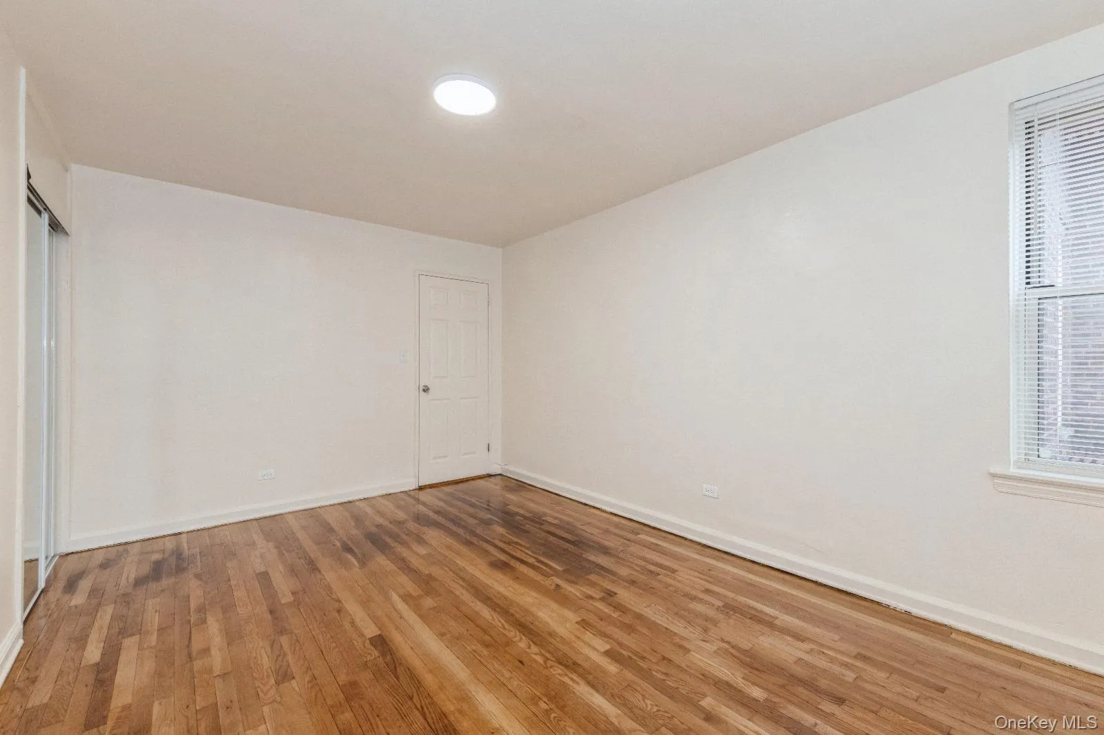 Empty room featuring baseboards and light wood-type flooring Empty room featuring baseboards and light wood-type flooring