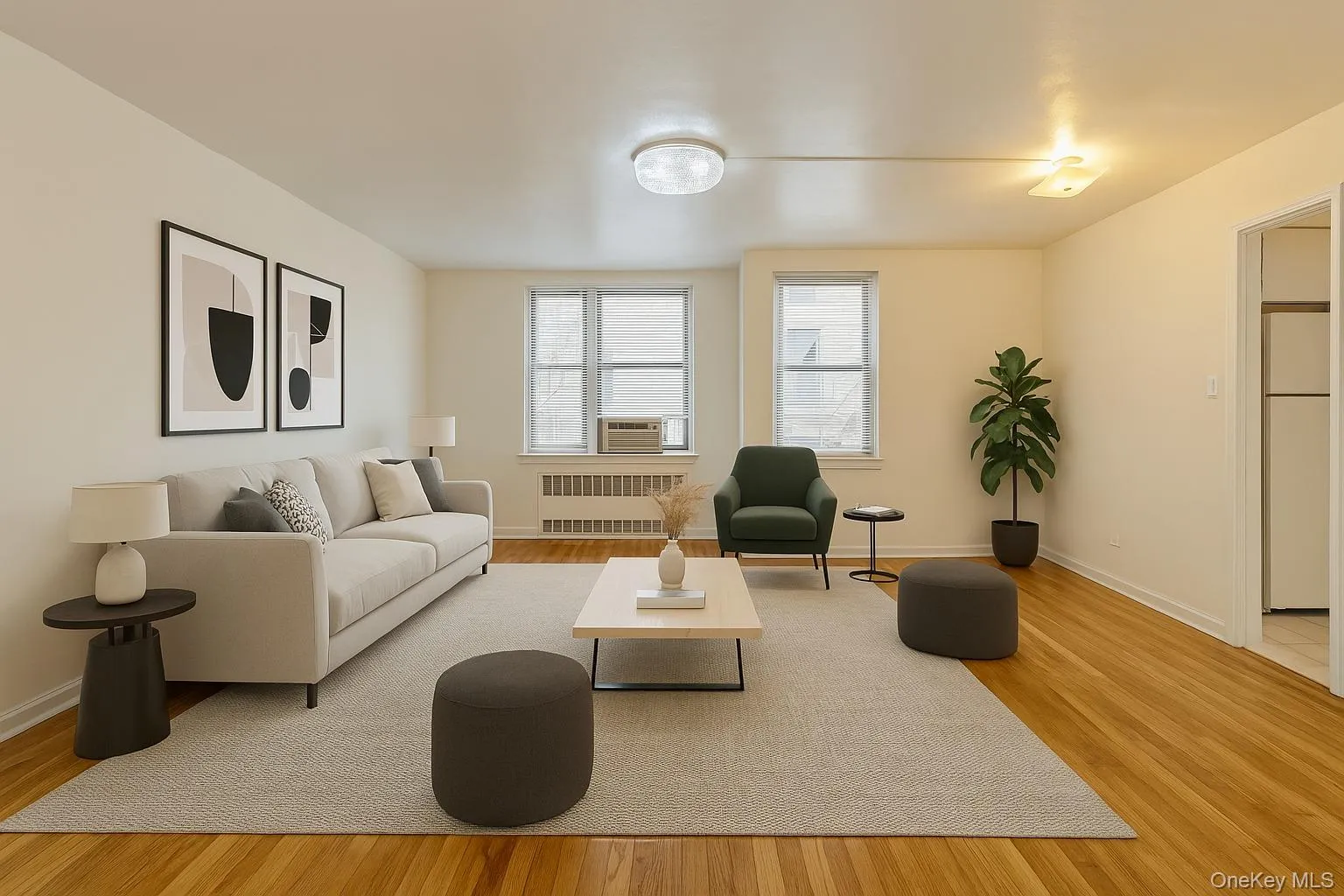 VS: Living area with radiator heating unit, wood finished floors, and baseboards VS: Living area with radiator heating unit, wood finished floors, and baseboards