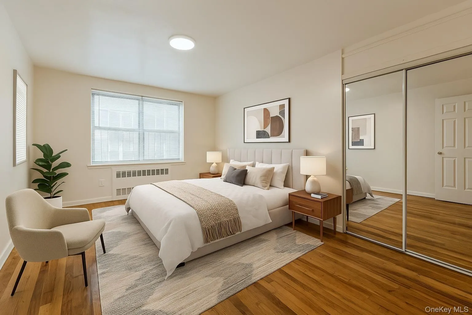 VS: Bedroom with a closet, baseboards, radiator, and wood finished floors VS: Bedroom with a closet, baseboards, radiator, and wood finished floors