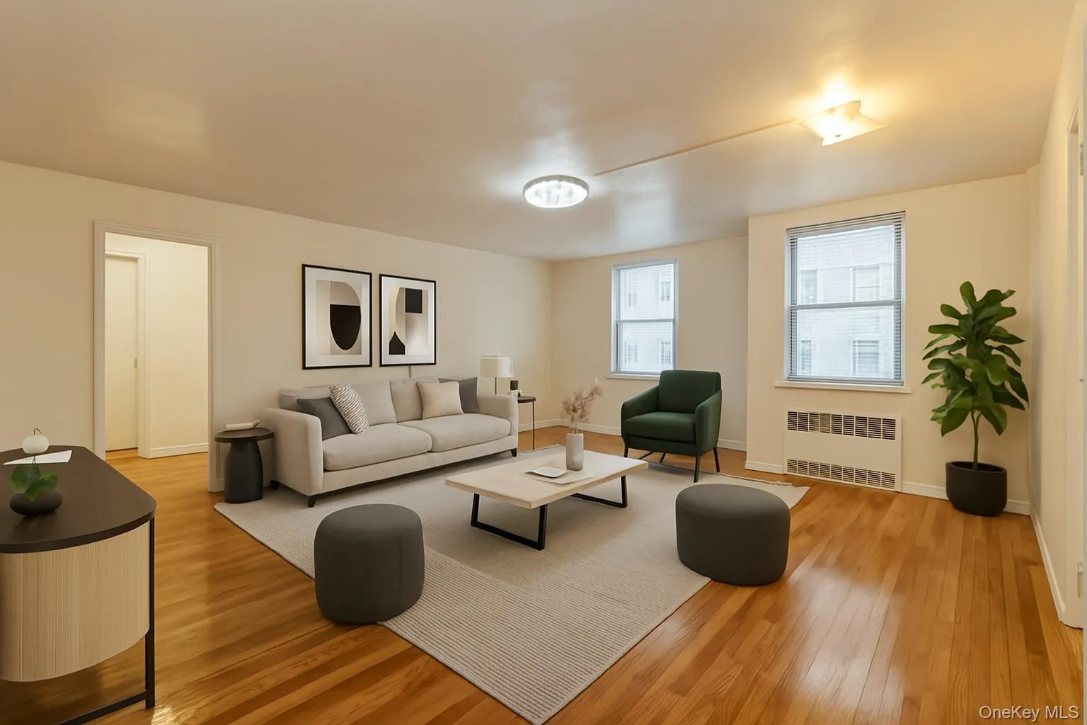 VS: Living room featuring radiator heating unit, wood finished floors, and baseboards VS: Living room featuring radiator heating unit, wood finished floors, and baseboards
