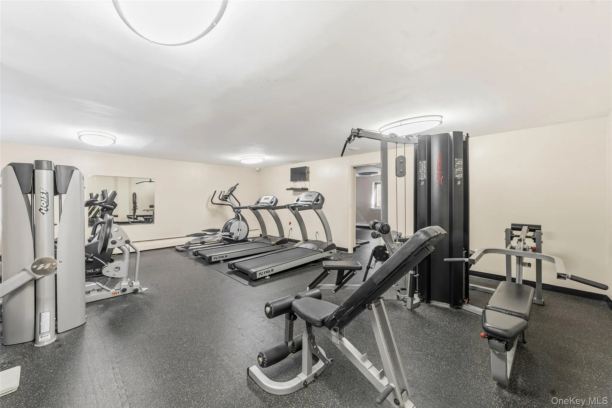 Fitness center featuring a variety of exercise equipment including treadmills, an elliptical, and resistance machines. The gym is located in the 2201 Palmer Avenue building. Fitness center featuring a variety of exercise equipment including treadmills, an elliptical, and resistance machines. The gym is located in the 2201 Palmer Avenue building.