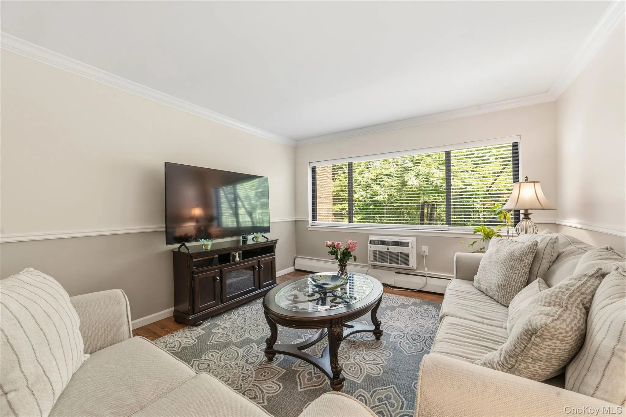 Modern living room with elegant crown molding and sleek chair-rail detail. Modern living room with elegant crown molding and sleek chair-rail detail.