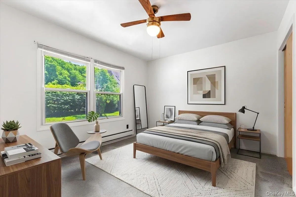 A bright bedroom with generous natural light and a simple, restful feel. A bright bedroom with generous natural light and a simple, restful feel.