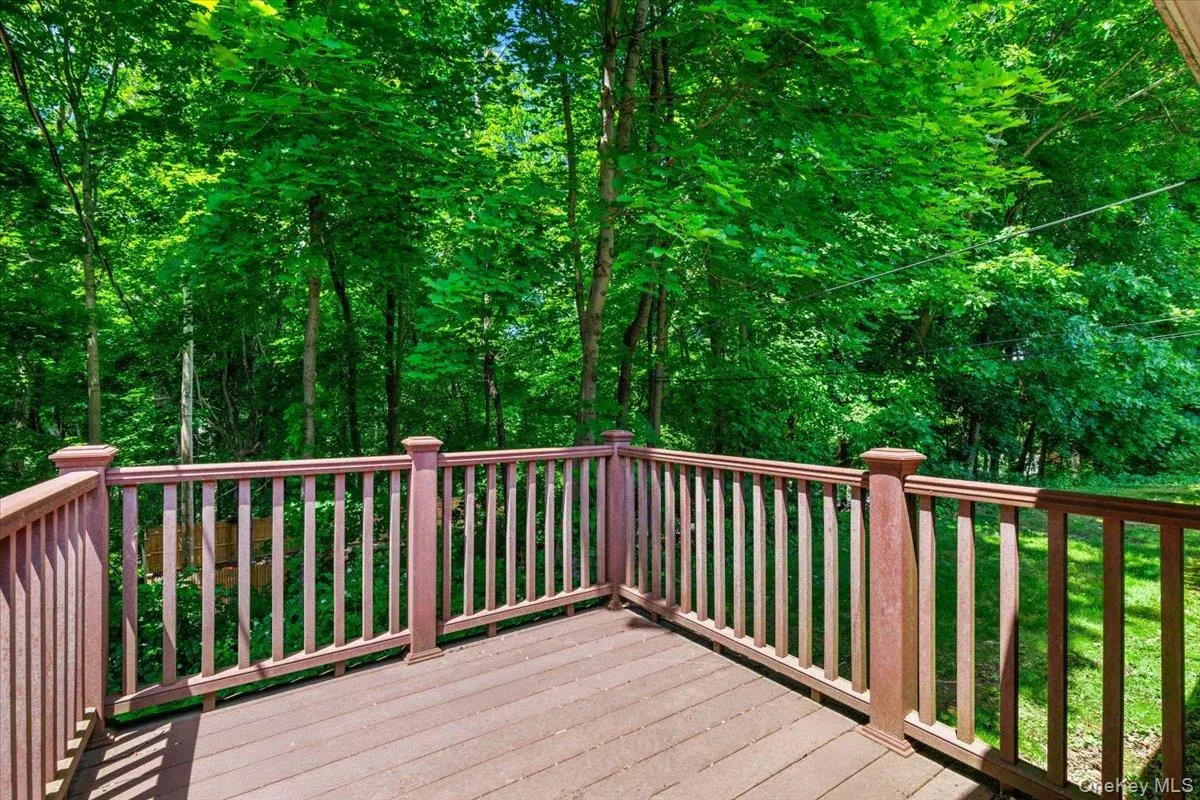 A private deck overlooking the surrounding trees, perfect for morning coffee or quiet outdoor enjoyment. A private deck overlooking the surrounding trees, perfect for morning coffee or quiet outdoor enjoyment.