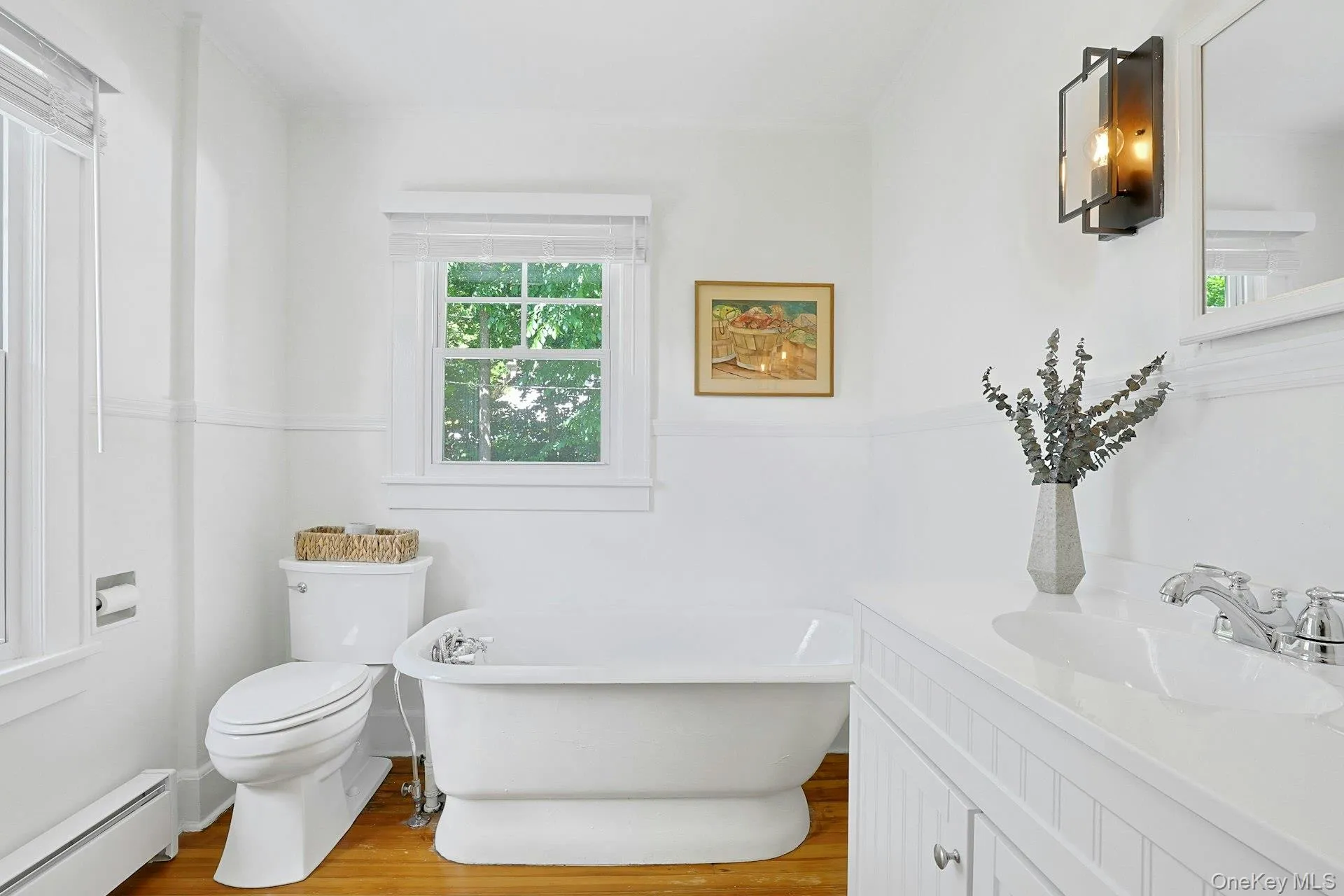 Second floor full bath with cast iron pedestal soaking tub and single vanity. Light, bright and airy bathroom. Second floor full bath with cast iron pedestal soaking tub and single vanity. Light, bright and airy bathroom.