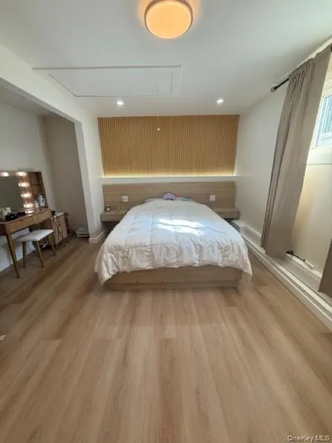 Bedroom featuring attic access, light wood-type flooring, and recessed lighting Bedroom featuring attic access, light wood-type flooring, and recessed lighting