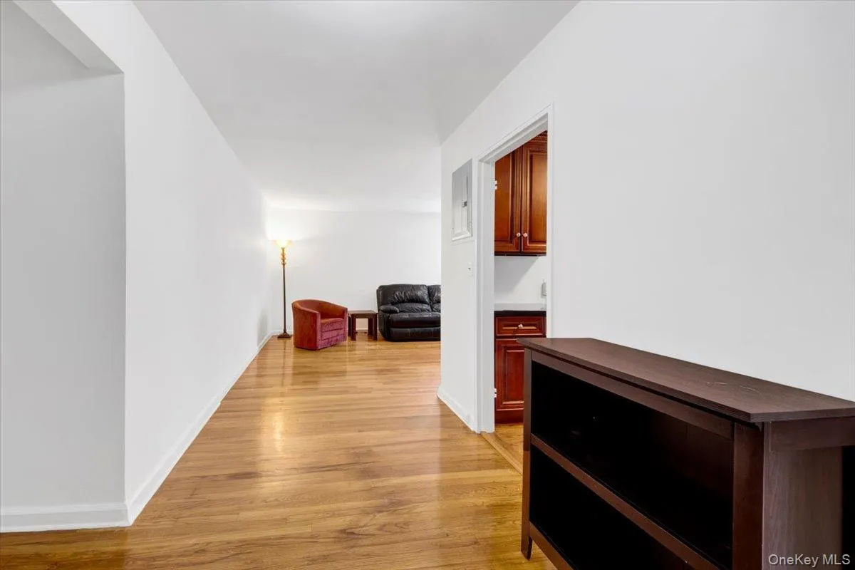 Hall featuring light wood flooring and baseboards Hall featuring light wood flooring and baseboards