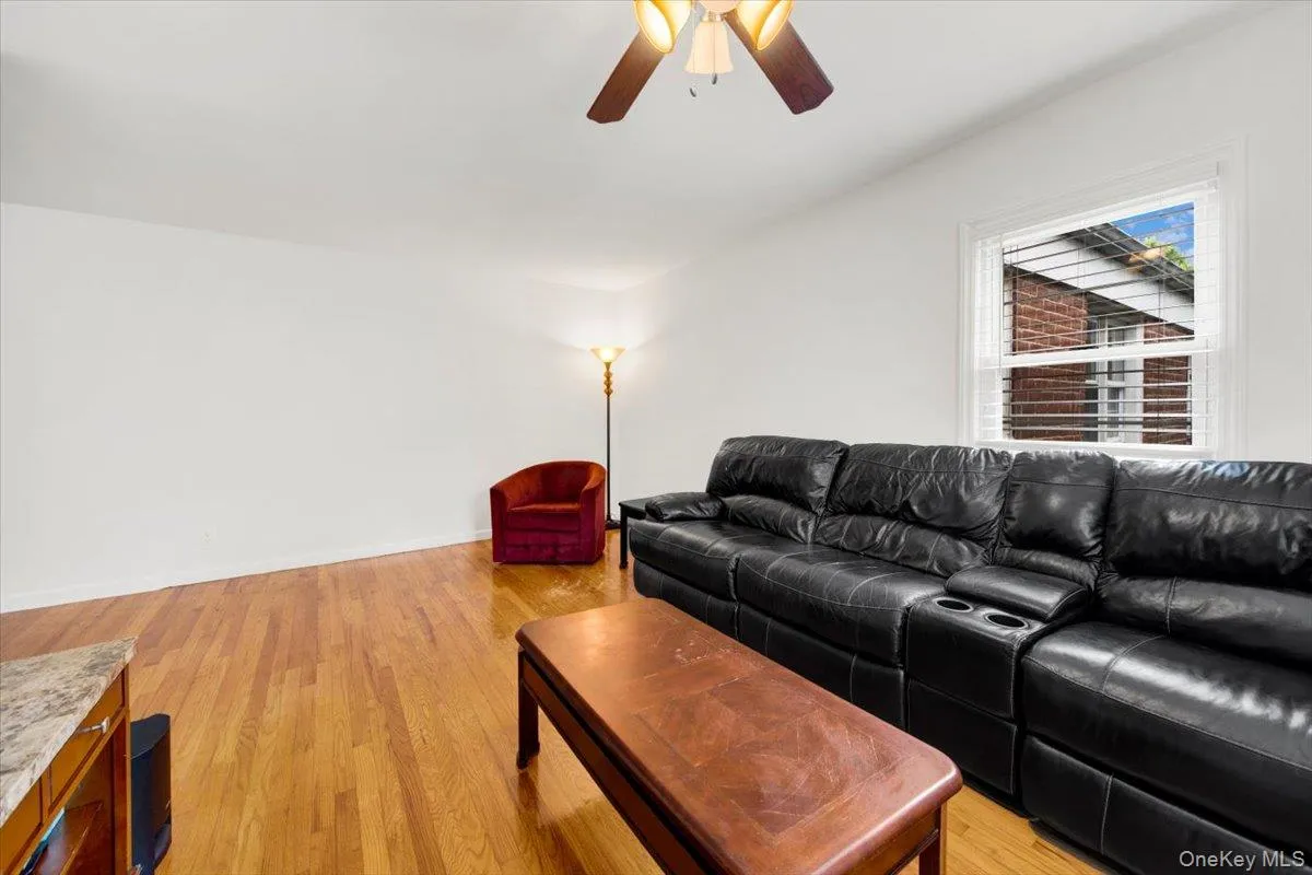 Living area featuring ceiling fan and light wood flooring Living area featuring ceiling fan and light wood flooring