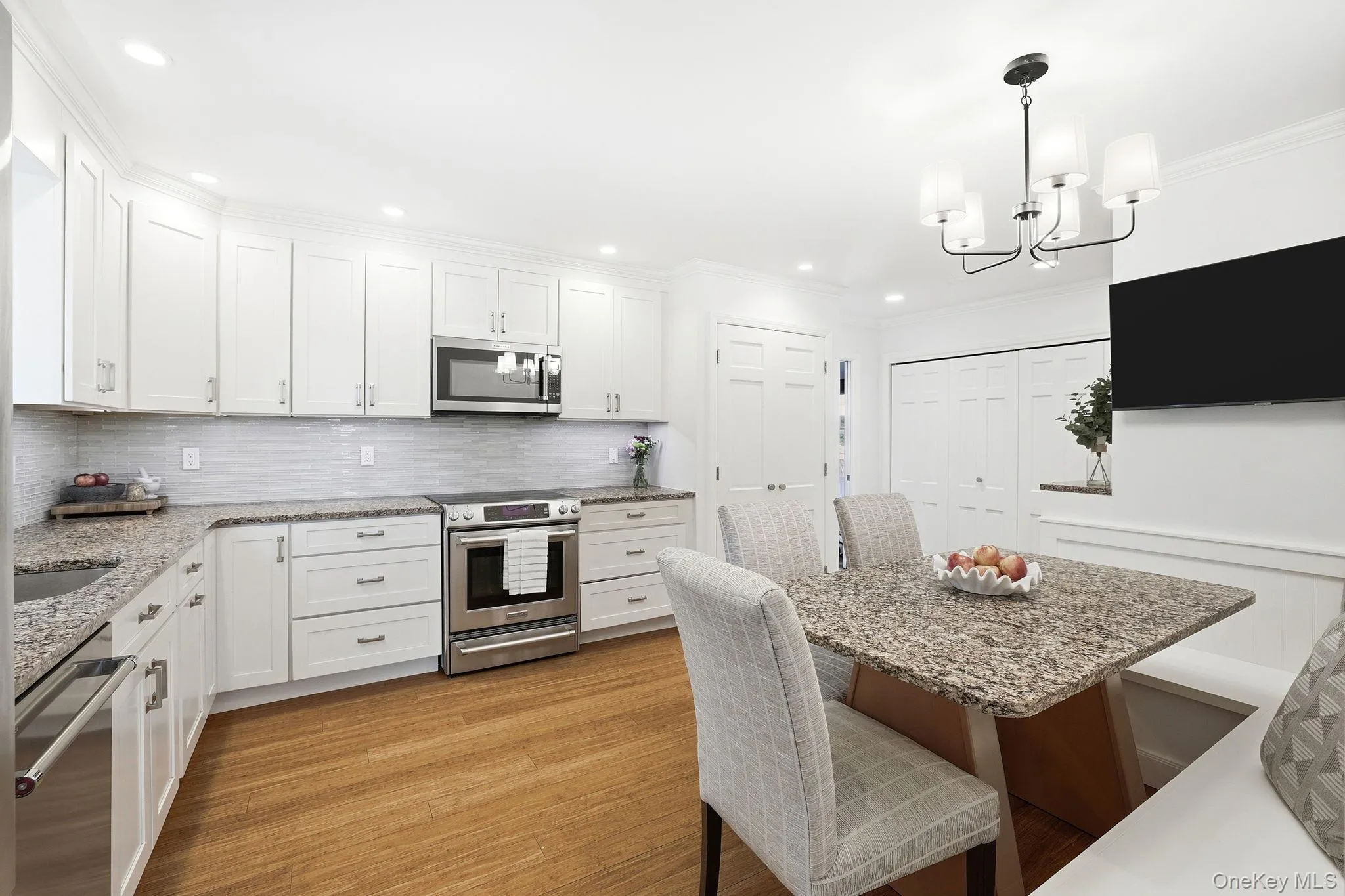 The kitchen's custom built-in banquette naturally transforms the space from a chef's dream into an inviting hub where guests naturally linger The kitchen's custom built-in banquette naturally transforms the space from a chef's dream into an inviting hub where guests naturally linger