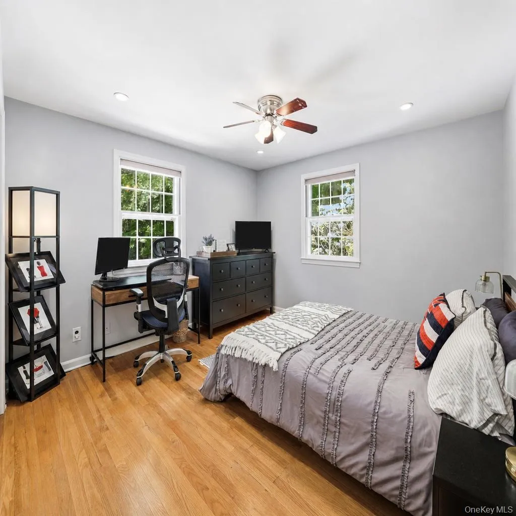 Fourth bedroom with hardwood floors and dual exposure windows overlooking the backyard Fourth bedroom with hardwood floors and dual exposure windows overlooking the backyard