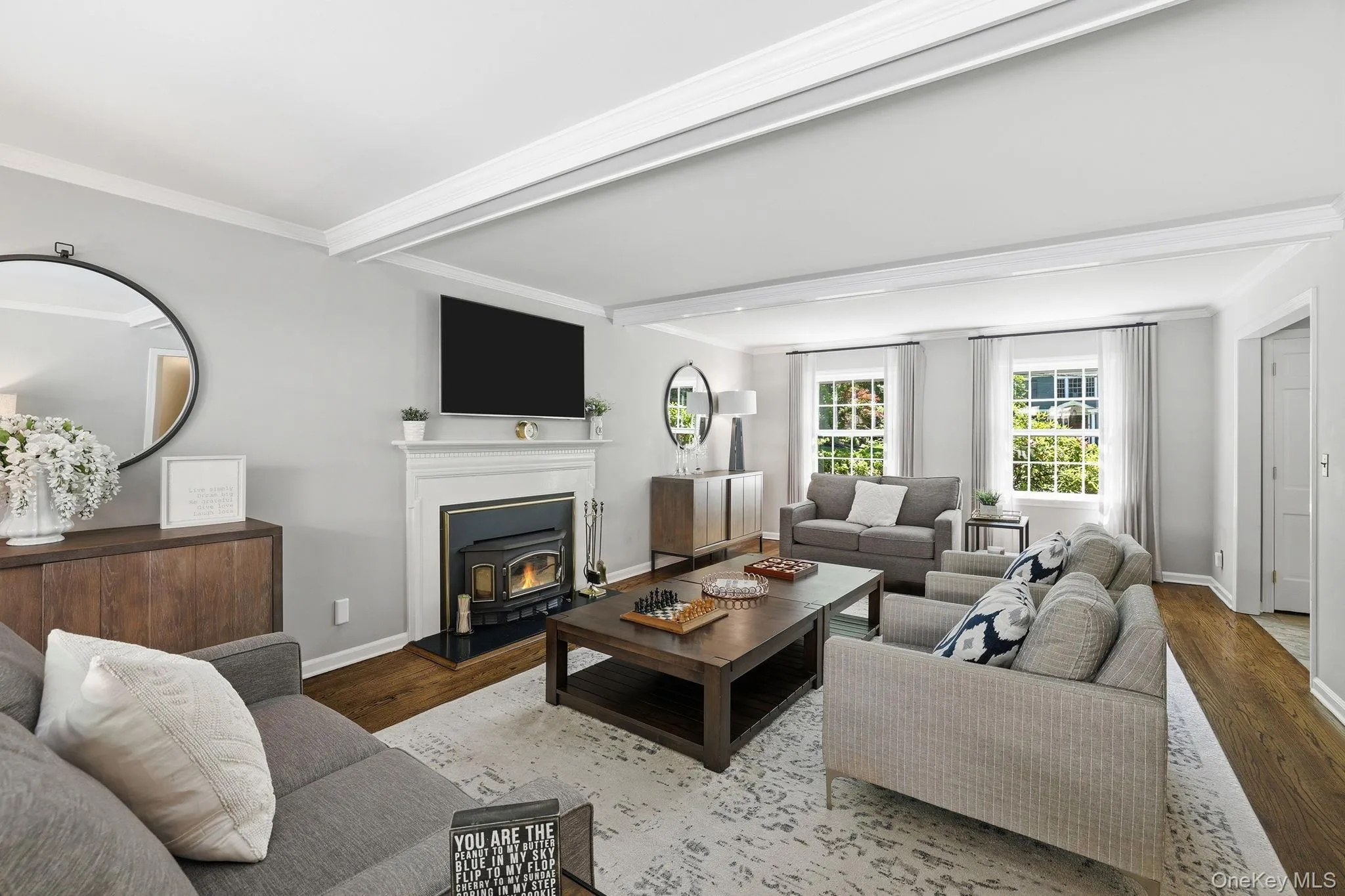 Bright formal living room highlighted by oversized windows overlooking both the front and rear yards and a cozy wood- burning stove Bright formal living room highlighted by oversized windows overlooking both the front and rear yards and a cozy wood- burning stove