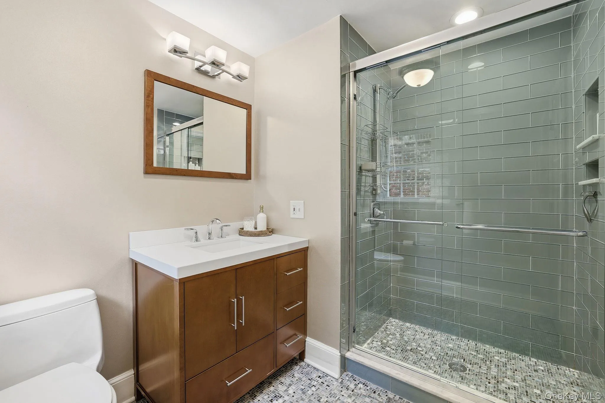 En suite primary bathroom with a large walk-in shower and linen closet En suite primary bathroom with a large walk-in shower and linen closet