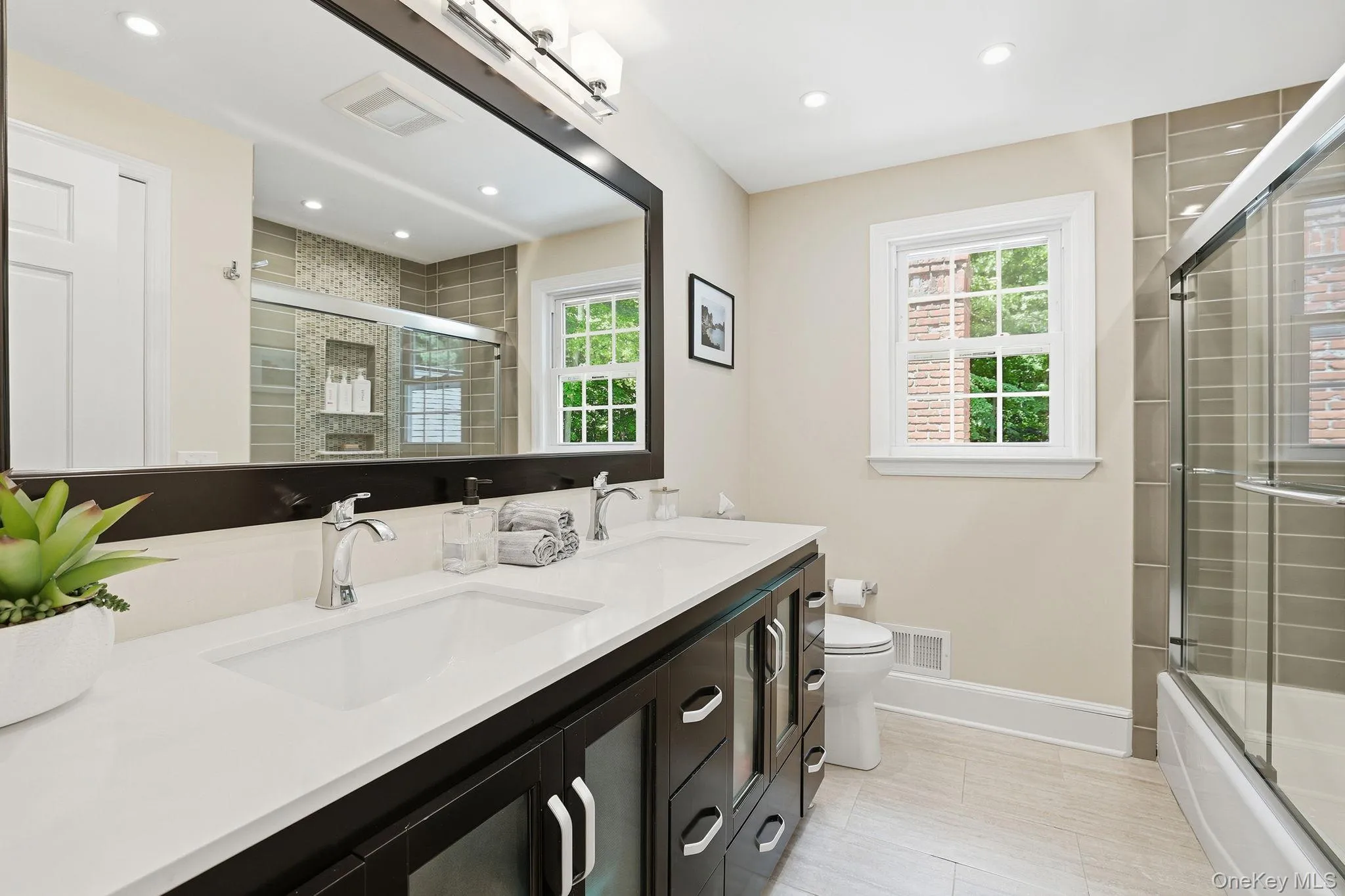 Hall bathroom with double sink vanity, shower tub combo and linen closet Hall bathroom with double sink vanity, shower tub combo and linen closet