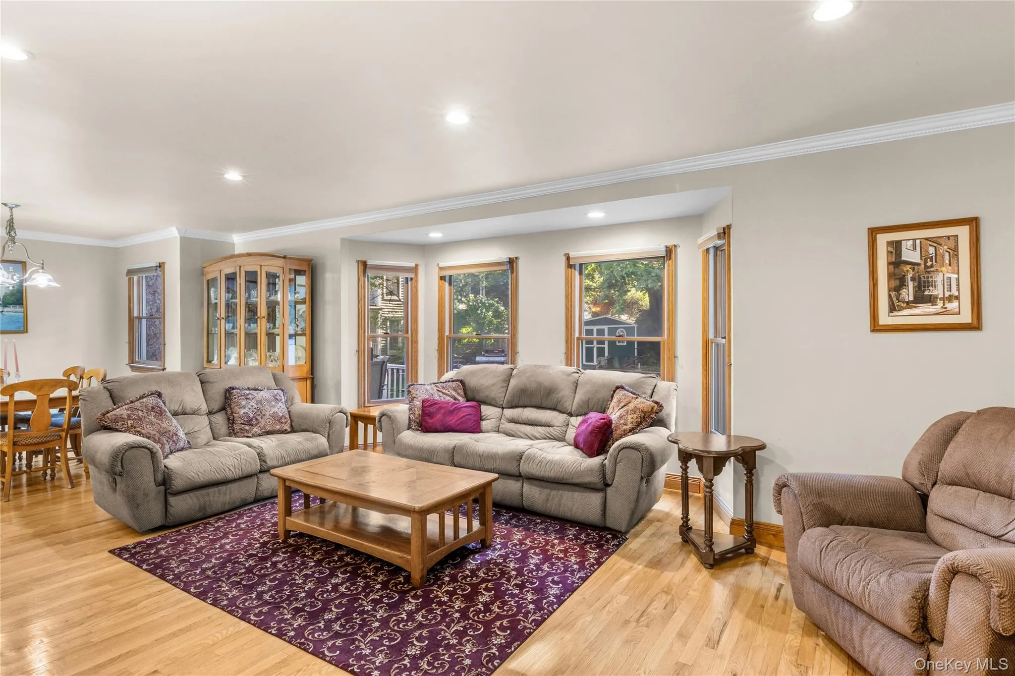 Living area with natural light and hardwood flooring Living area with natural light and hardwood flooring