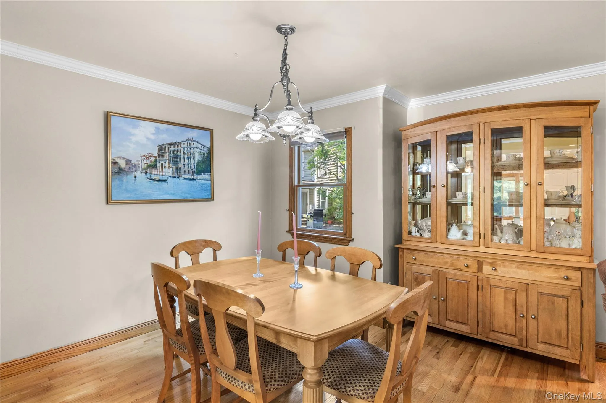 Hardwood flooring extends throughout this room, featuring crown molding Hardwood flooring extends throughout this room, featuring crown molding