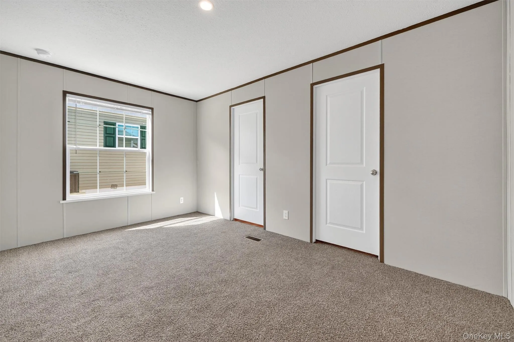 Unfurnished bedroom featuring carpet floors, ornamental molding, and recessed lighting Unfurnished bedroom featuring carpet floors, ornamental molding, and recessed lighting