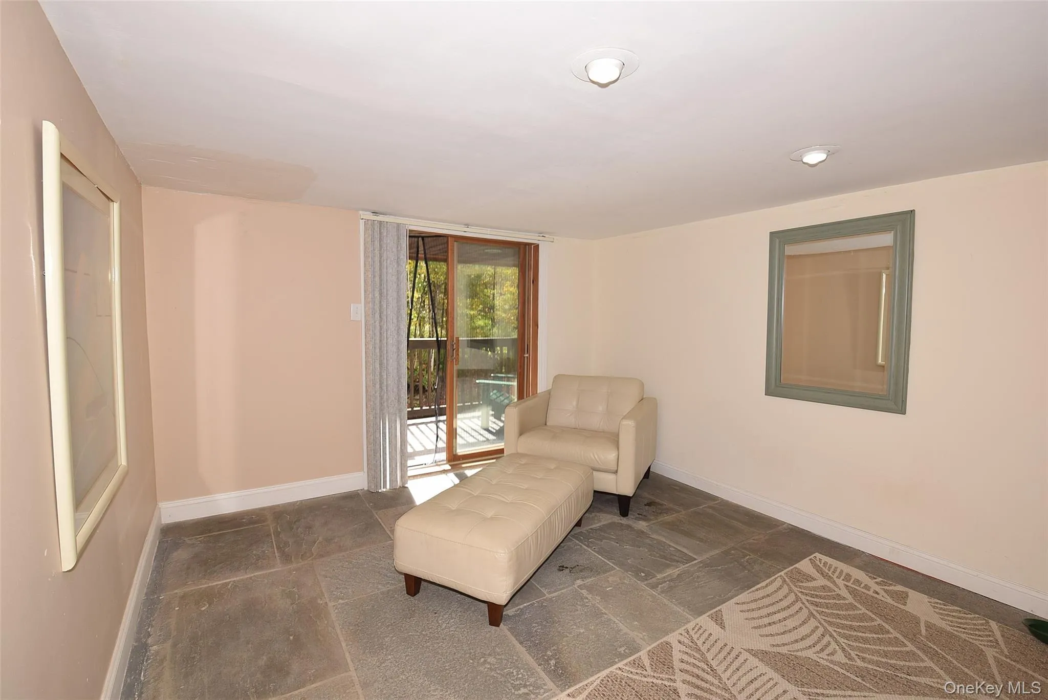 Living area with baseboards and stone tile flooring Living area with baseboards and stone tile flooring