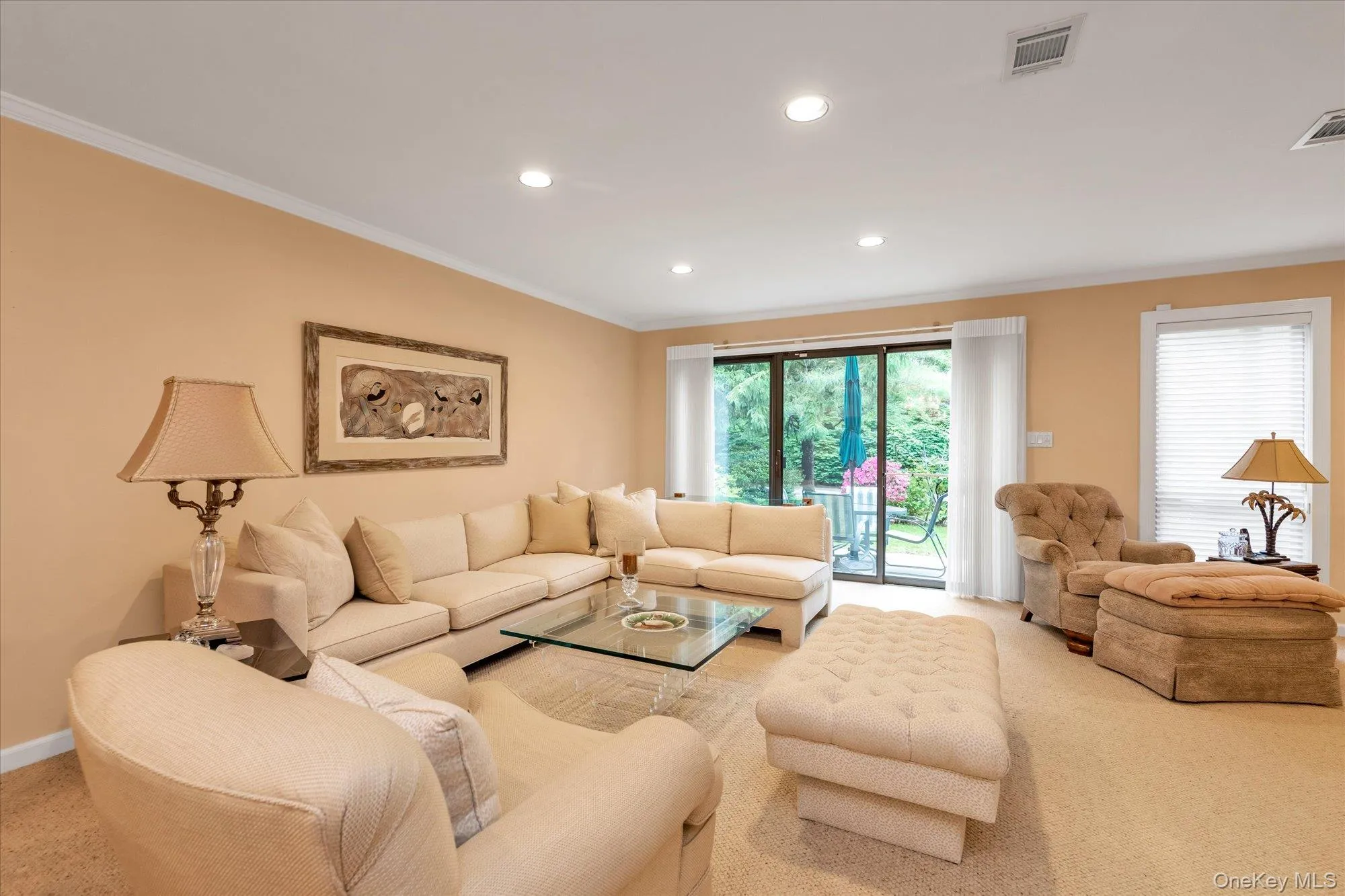 Living area featuring light beige wall tones and recessed lighting Living area featuring light beige wall tones and recessed lighting