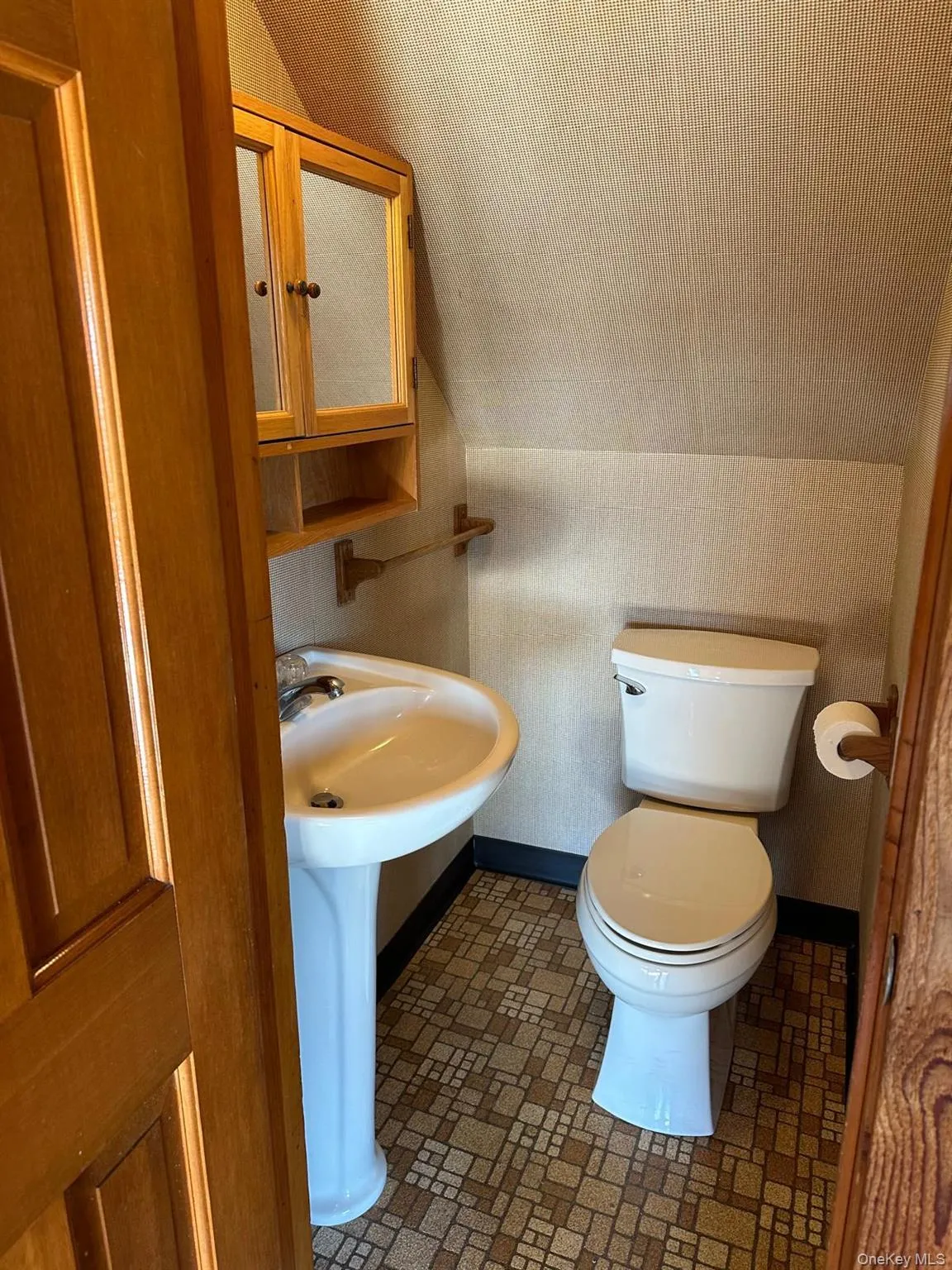 Powder room featuring toilet and sink Powder room featuring toilet and sink