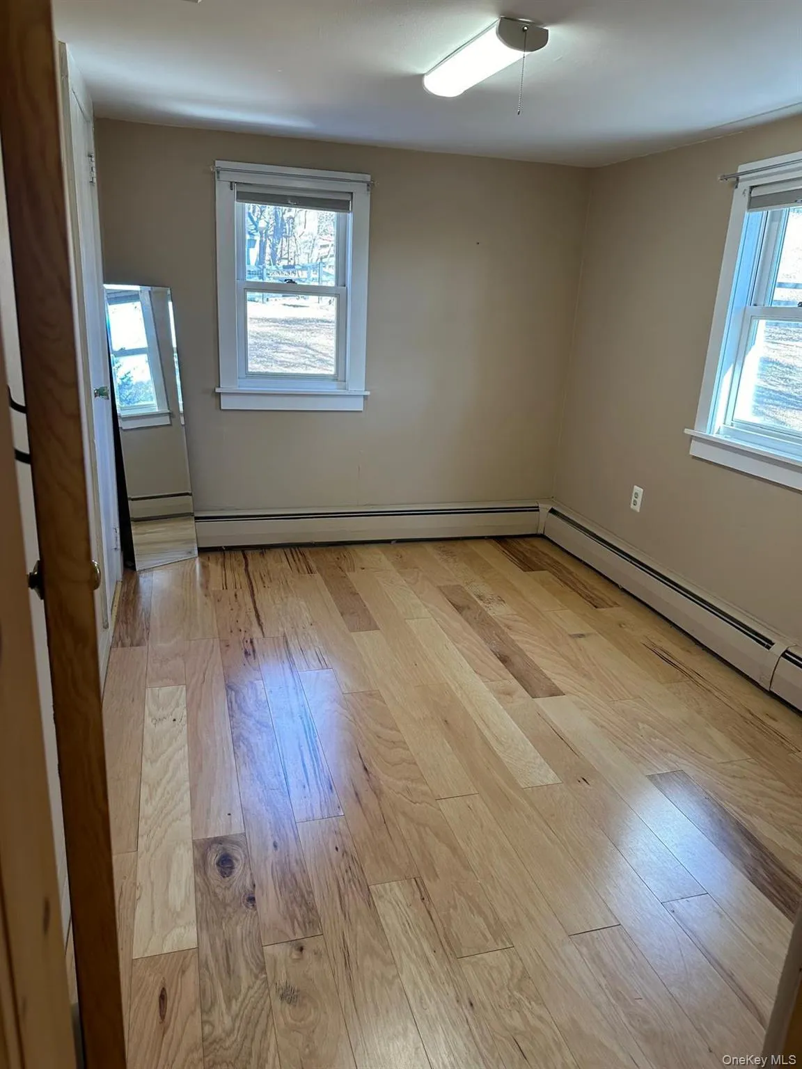 Bedroom featuring plenty of natural light and light wood-style vinyl floors Bedroom featuring plenty of natural light and light wood-style vinyl floors