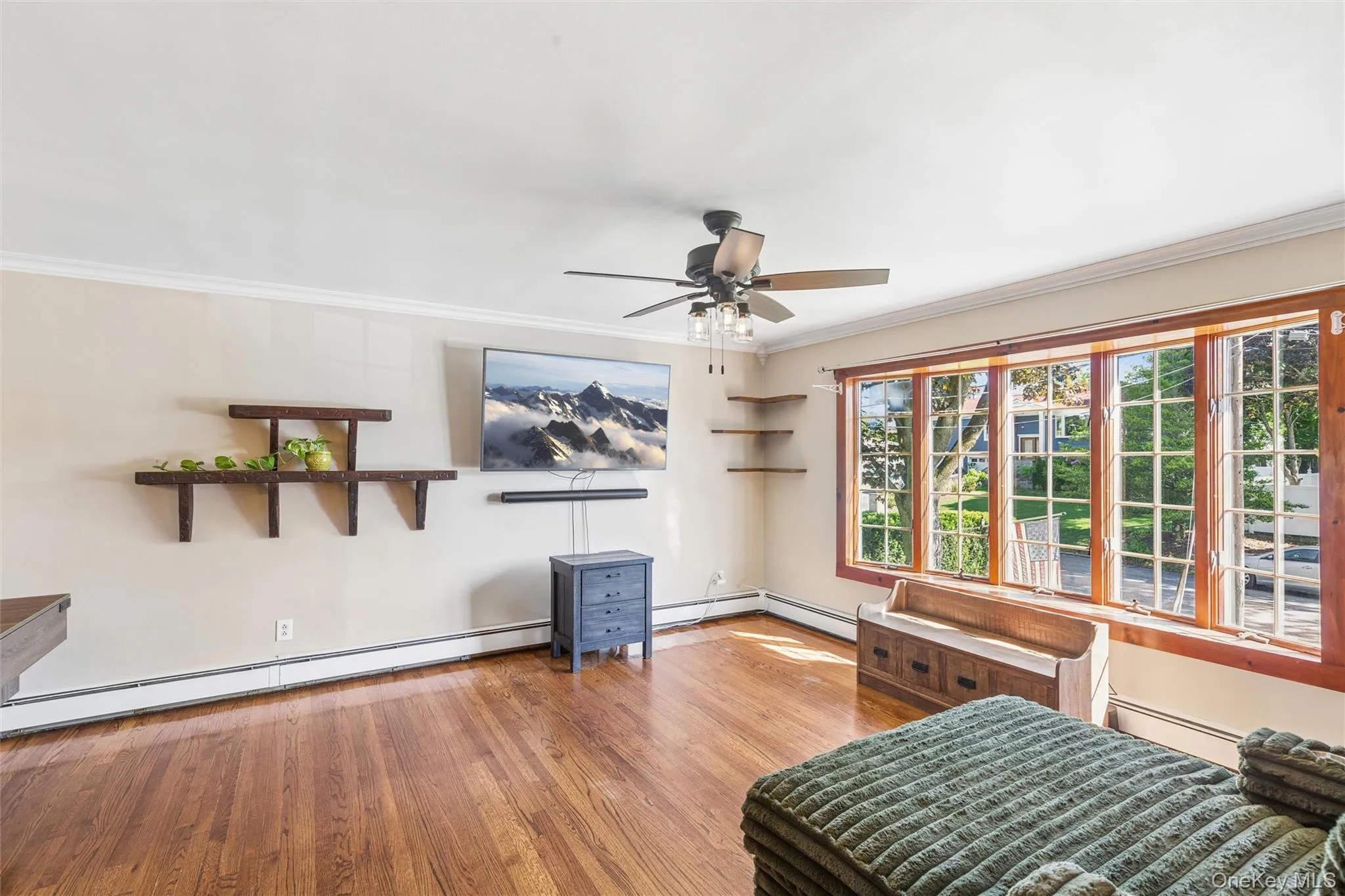 Sun drenched spacious room with natural wood large bay window and hardwood flooring Sun drenched spacious room with natural wood large bay window and hardwood flooring