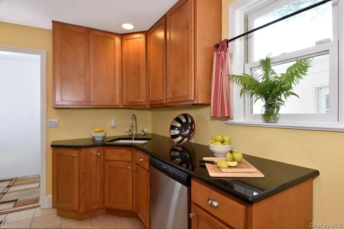 Kitchen with wood cabinets and stone countertop. Kitchen with wood cabinets and stone countertop.
