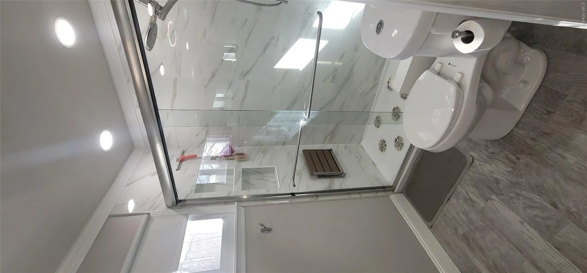 Full bathroom with toilet, baseboards, recessed lighting, and a shower stall Full bathroom with toilet, baseboards, recessed lighting, and a shower stall