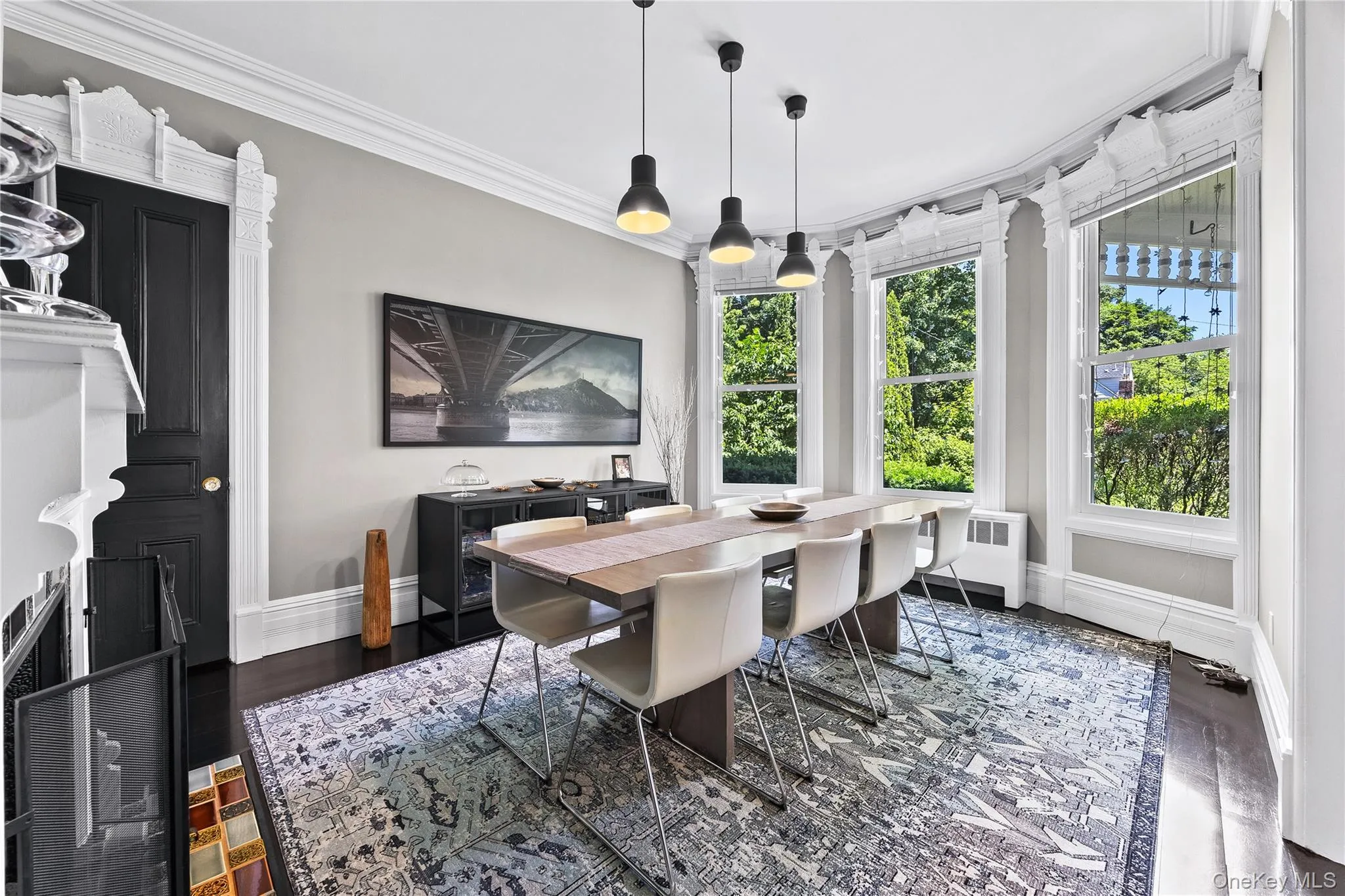 Formal dining area featuring dark wood-finish flooring Formal dining area featuring dark wood-finish flooring