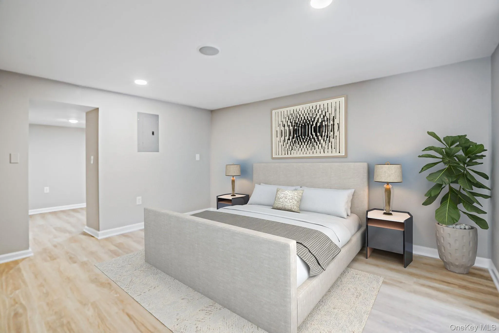 Room featuring light wood-finish flooring, recessed lighting, and a neutral color palette Room featuring light wood-finish flooring, recessed lighting, and a neutral color palette