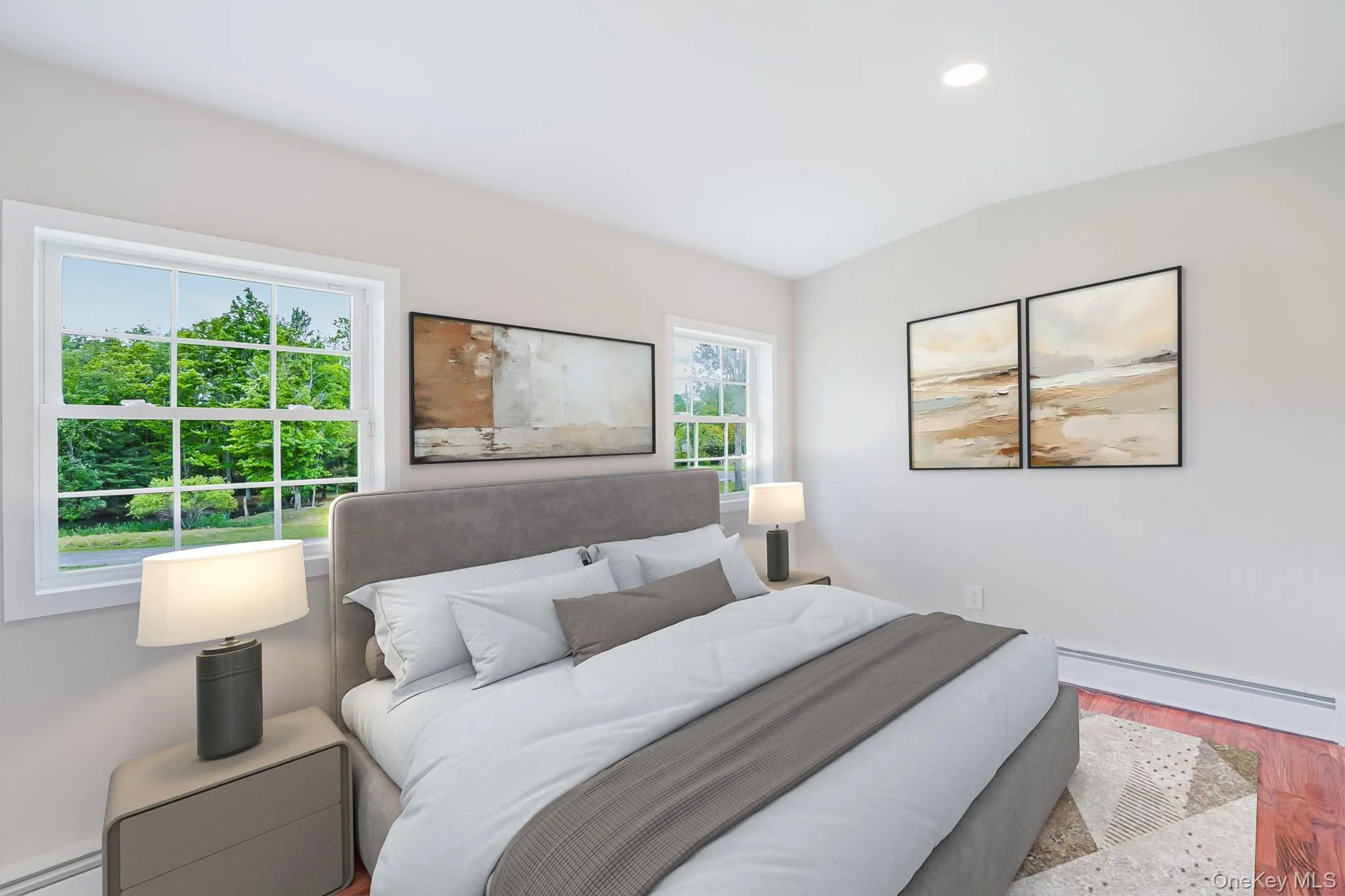 Bright interior space featuring two large windows, recessed ceiling lighting, baseboard heating, and wood-finish flooring Bright interior space featuring two large windows, recessed ceiling lighting, baseboard heating, and wood-finish flooring