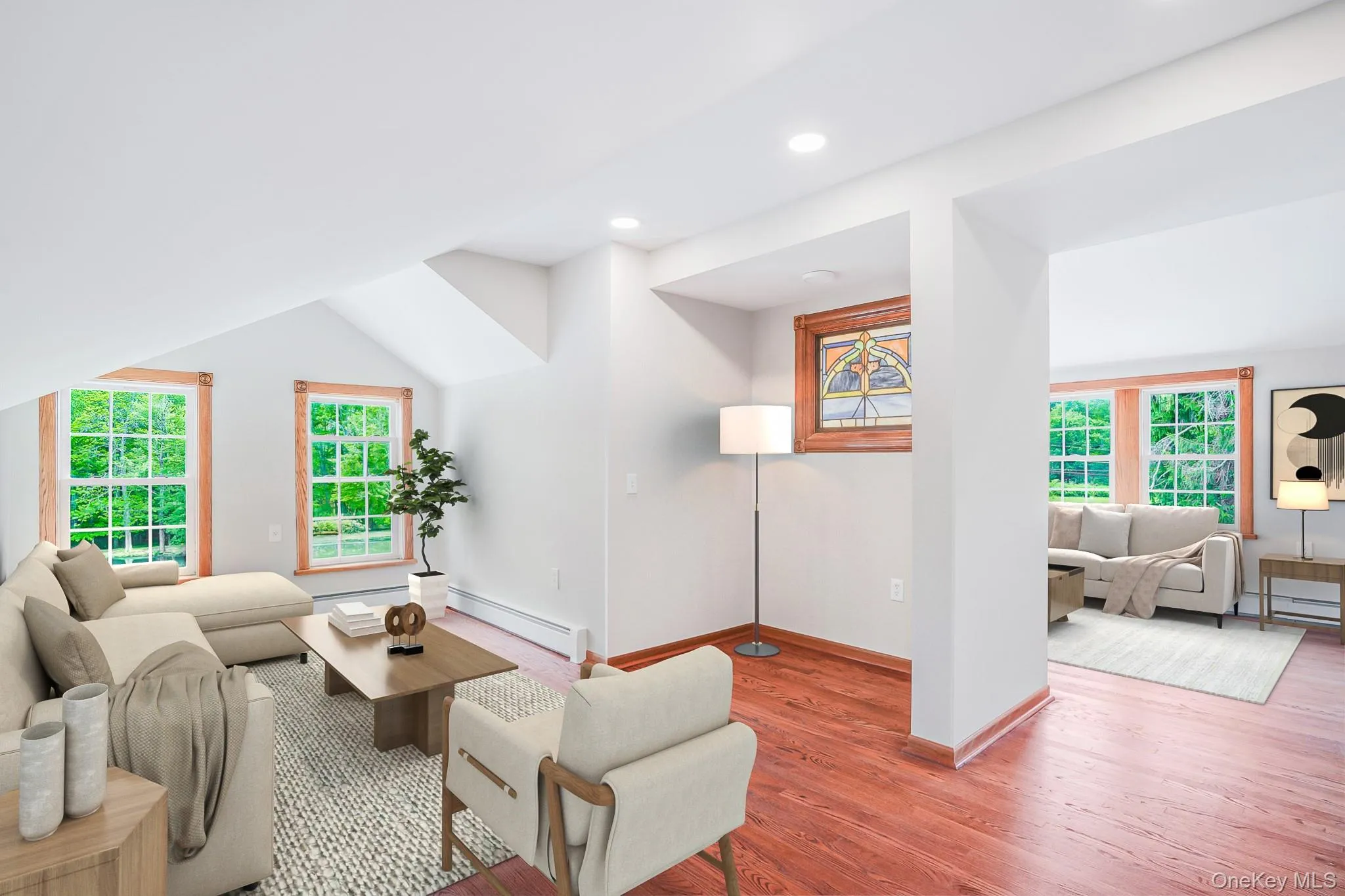 Interior space featuring hardwood flooring, white walls, recessed lighting, and sloped ceilings Interior space featuring hardwood flooring, white walls, recessed lighting, and sloped ceilings