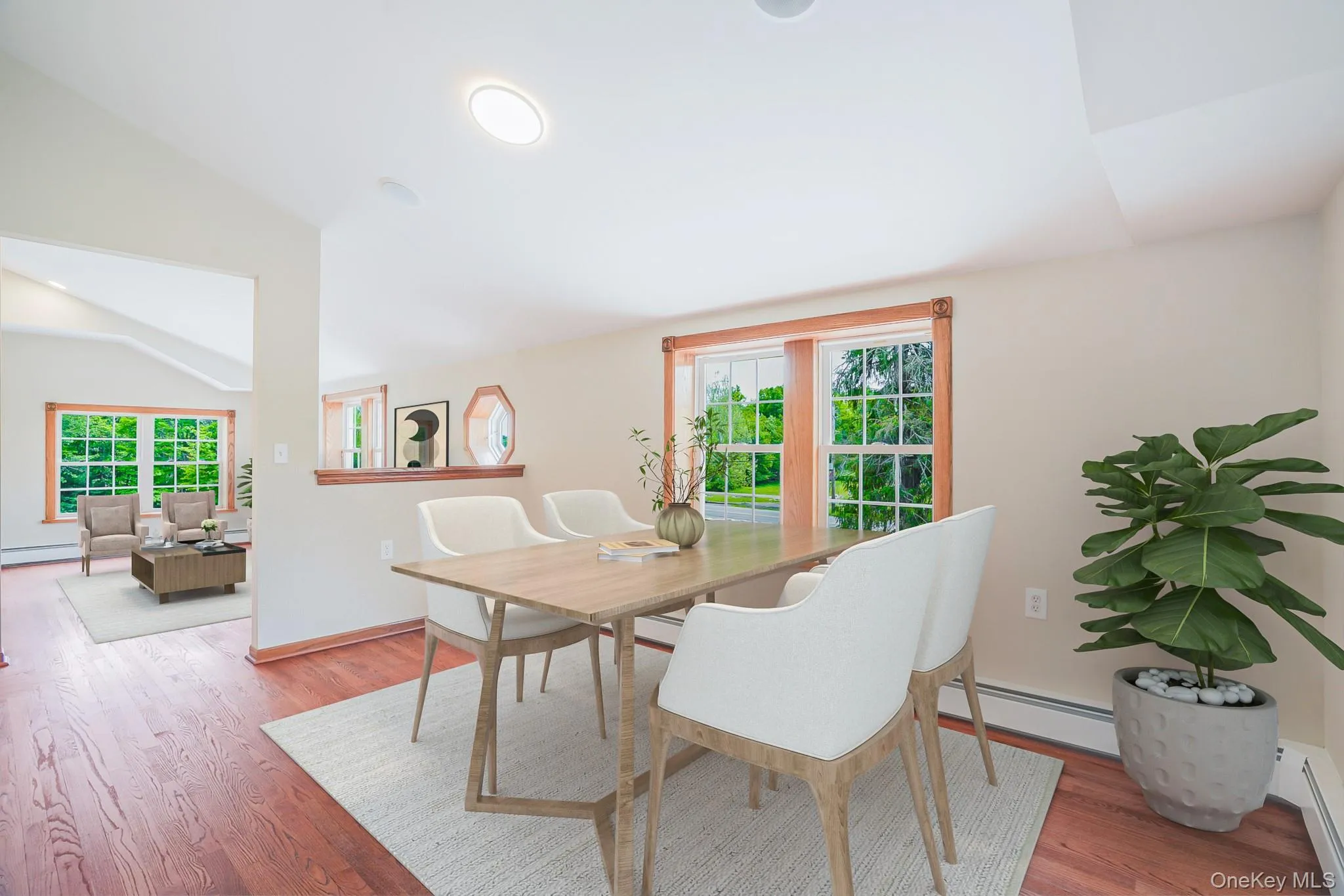 Dining area featuring rich wood-finish flooring, a recessed ceiling light, and a half-wall partition Dining area featuring rich wood-finish flooring, a recessed ceiling light, and a half-wall partition