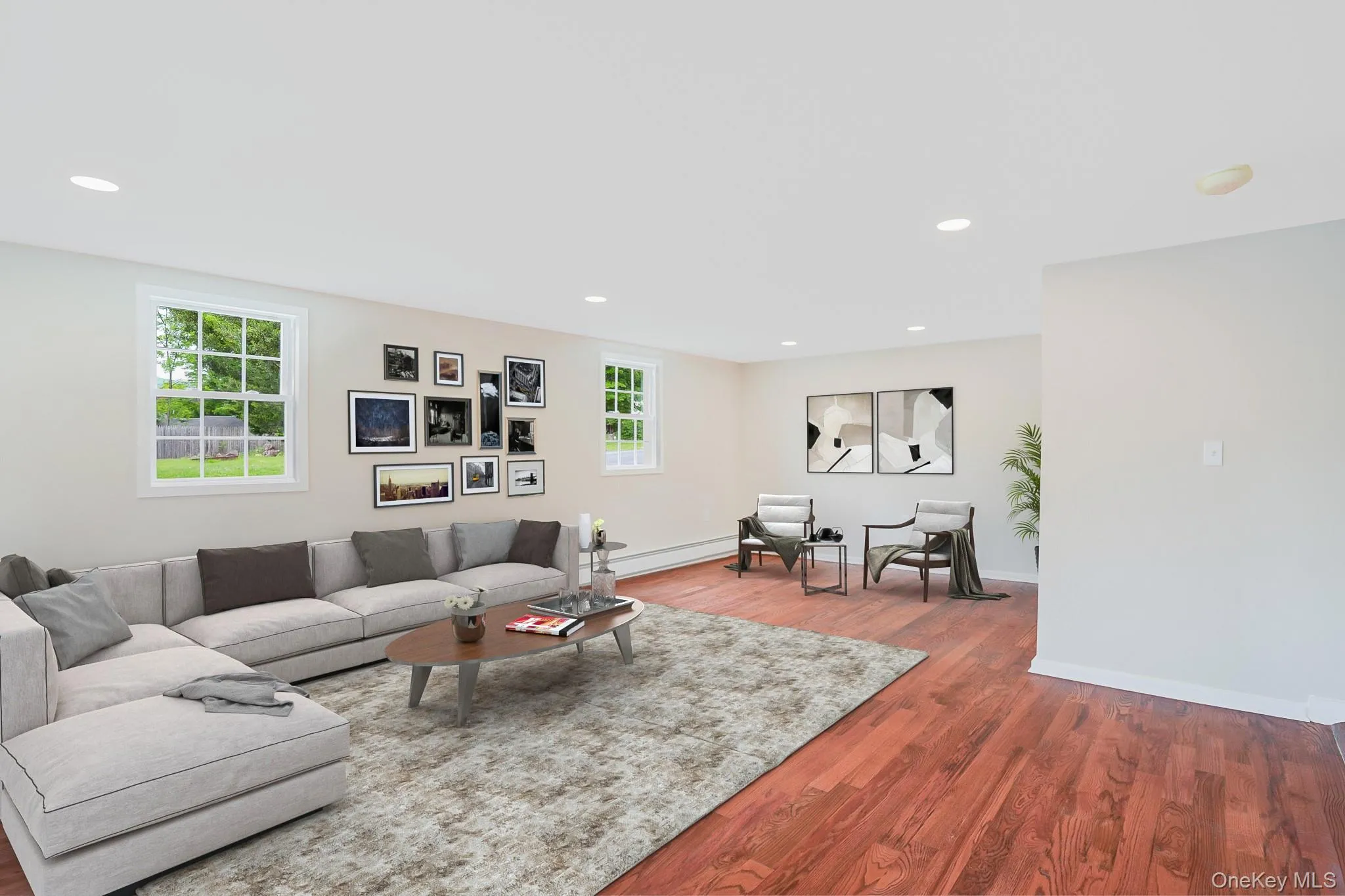Spacious interior featuring wood-finish flooring, recessed lighting, and multiple windows Spacious interior featuring wood-finish flooring, recessed lighting, and multiple windows