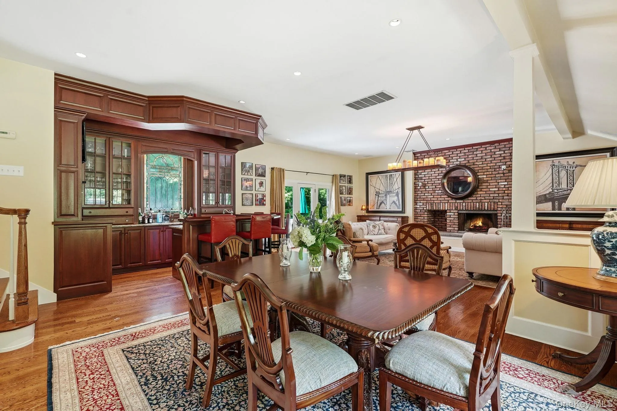 Formal dining room with bar in the background. Formal dining room with bar in the background.