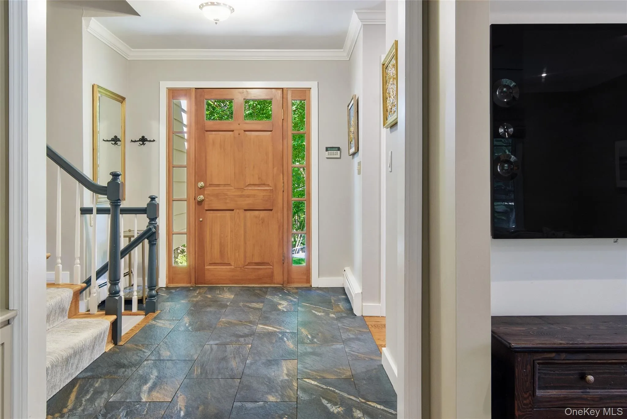 Crown molding, 12 x 24 floor tile, and entry door with sidelights Crown molding, 12 x 24 floor tile, and entry door with sidelights