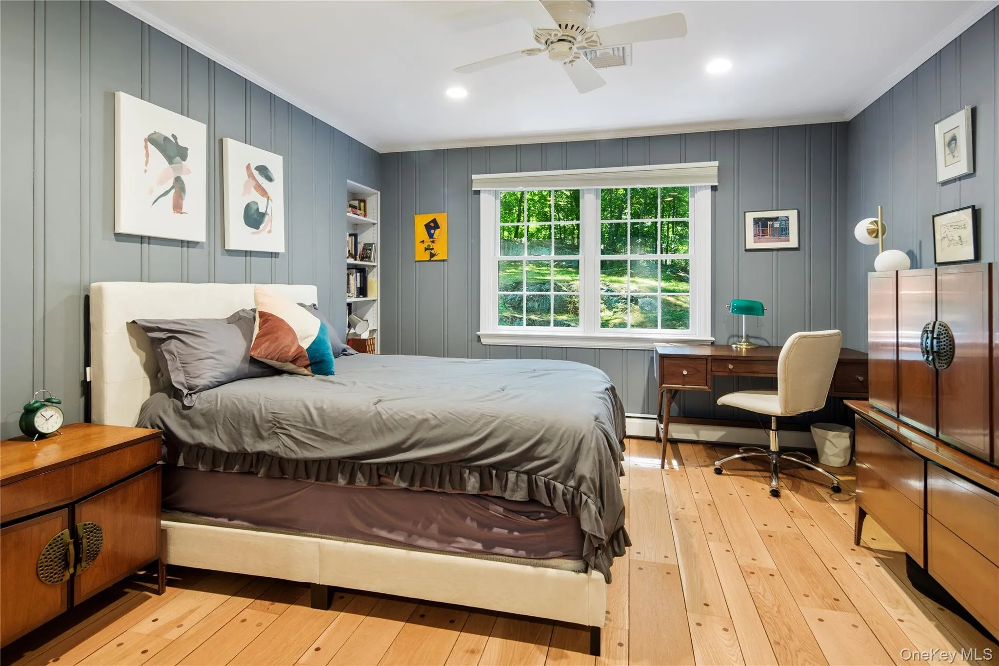 Bedroom 2 has tongue and groove wood wall paneling, wide board peg oak floors, crown molding, recessed lighting, double closet and a ceiling fan Bedroom 2 has tongue and groove wood wall paneling, wide board peg oak floors, crown molding, recessed lighting, double closet and a ceiling fan