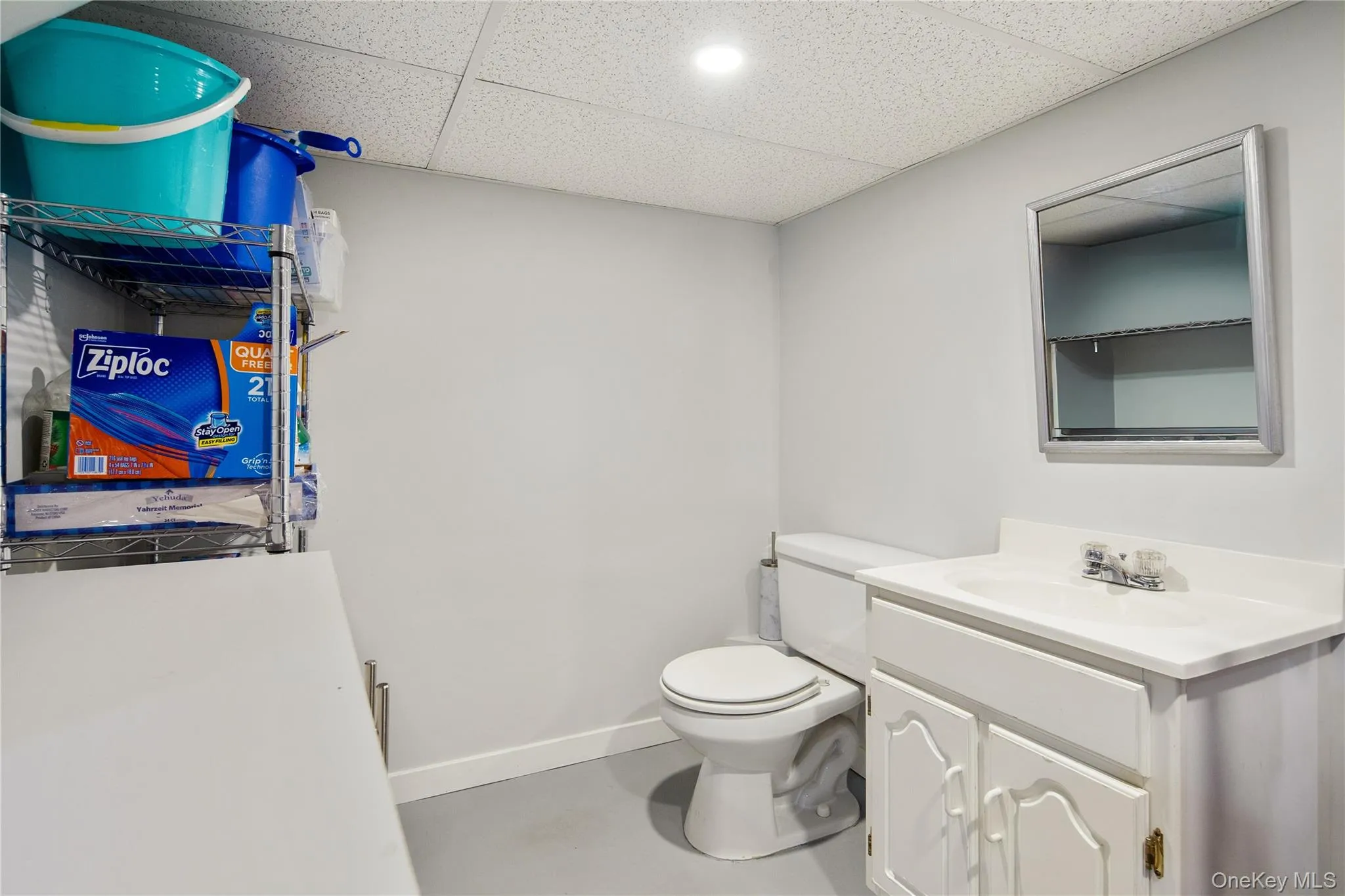 Powder room tucked into mechanical/storage room Powder room tucked into mechanical/storage room