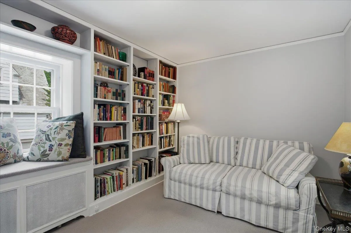 Built-in white bookshelves with extensive storage Built-in white bookshelves with extensive storage