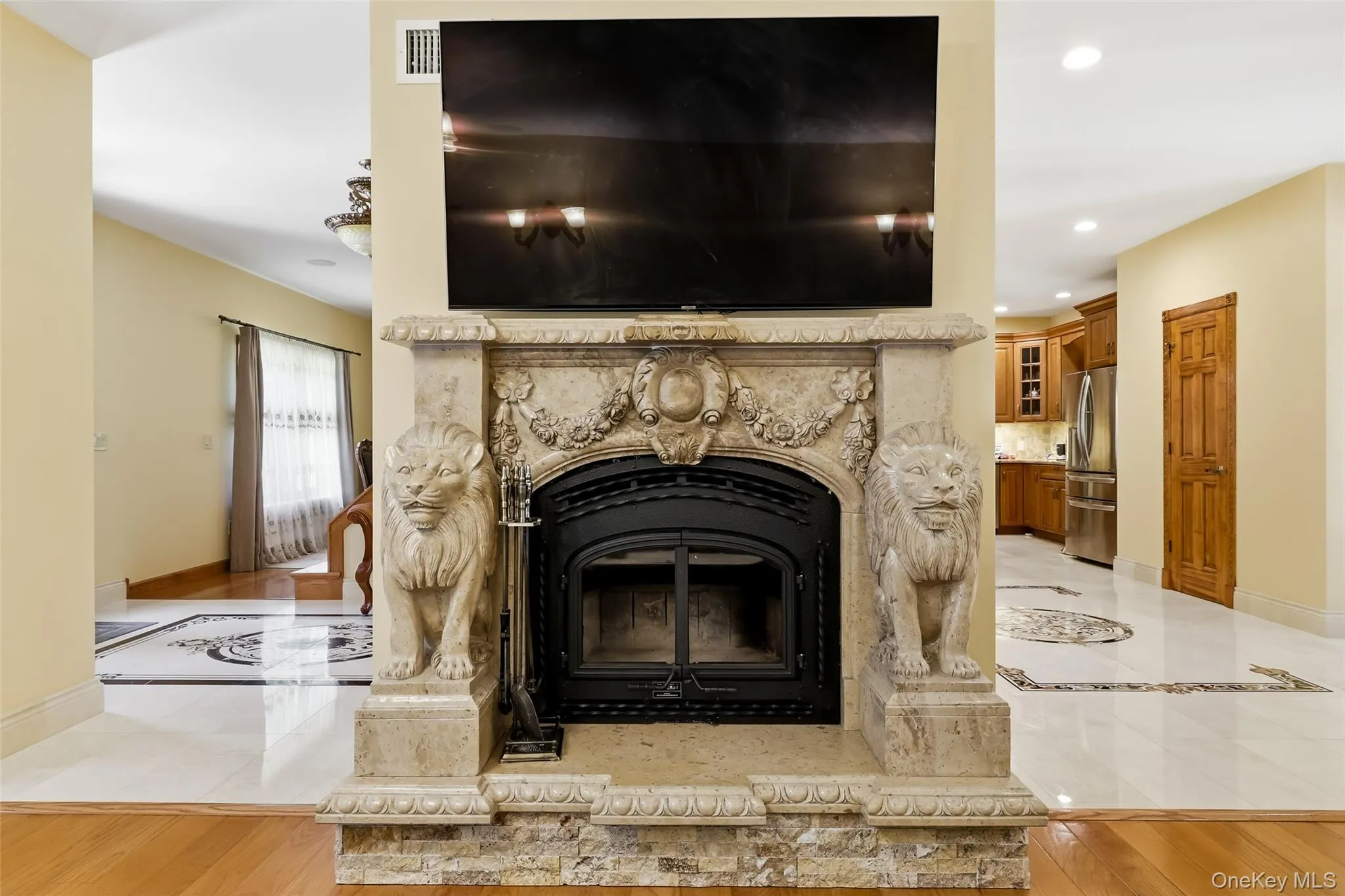Ornate fireplace featuring carved lion figures and a stone surround with intricate detailing Ornate fireplace featuring carved lion figures and a stone surround with intricate detailing