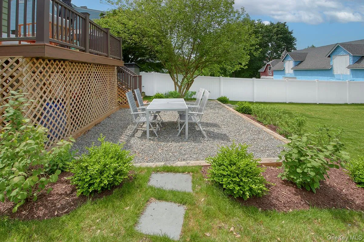 View of yard with a deck, a patio, stairway, and outdoor dining space View of yard with a deck, a patio, stairway, and outdoor dining space