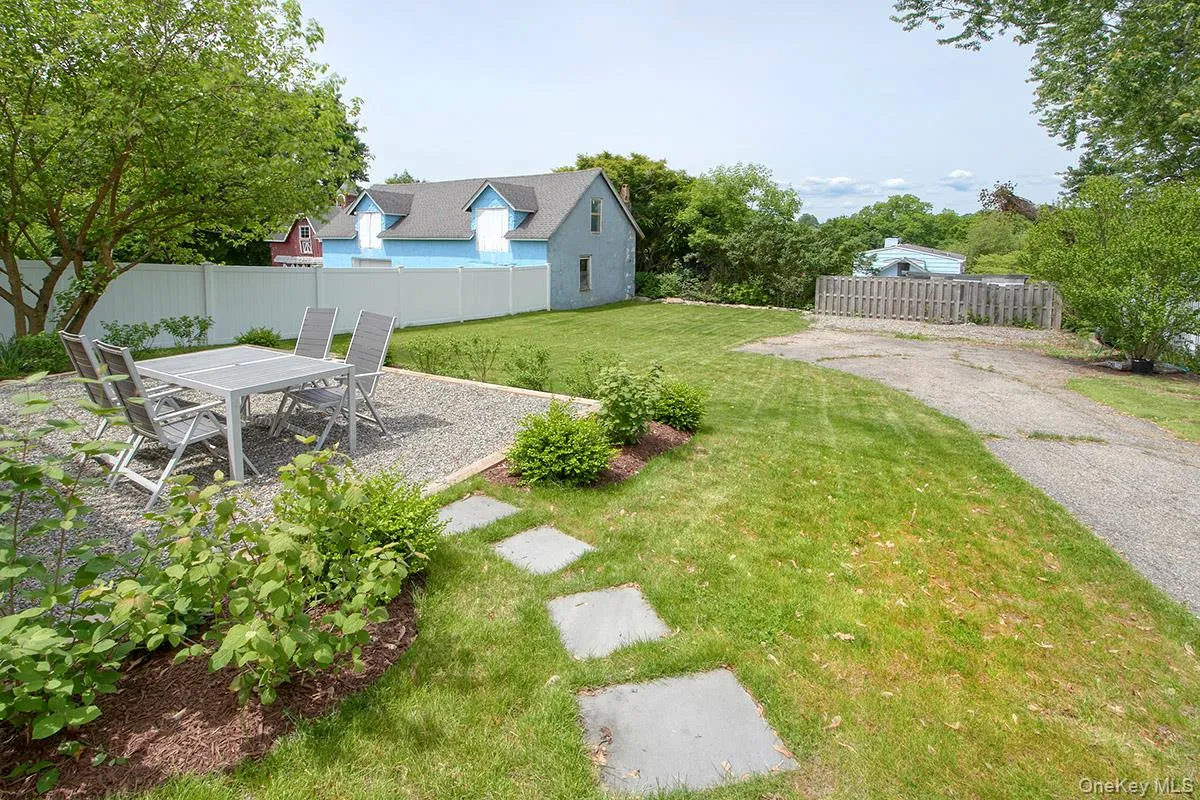 View of yard with a patio area and outdoor dining area View of yard with a patio area and outdoor dining area