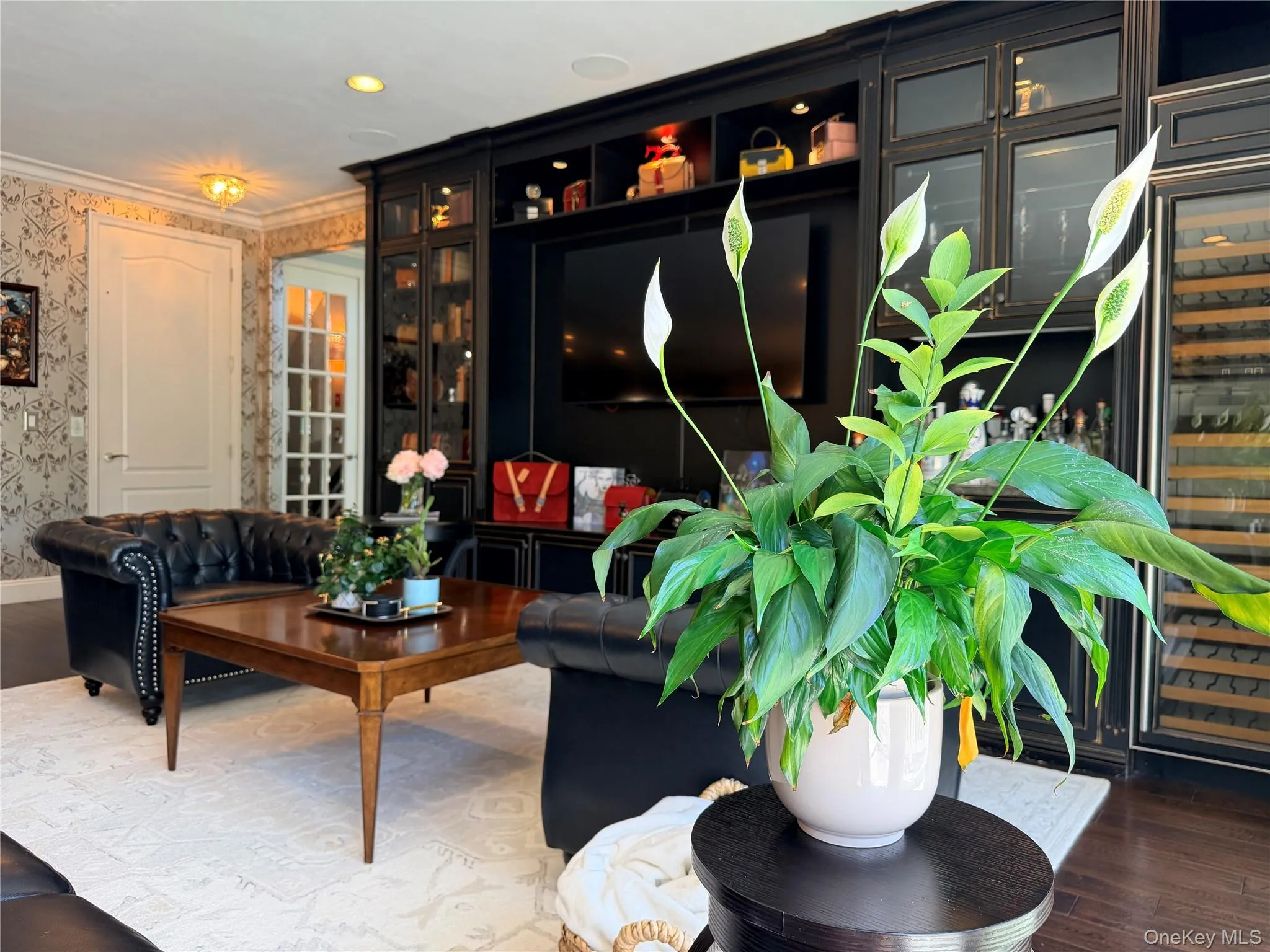 Built-in media cabinet featuring open shelving and glass-front display cabinets Built-in media cabinet featuring open shelving and glass-front display cabinets